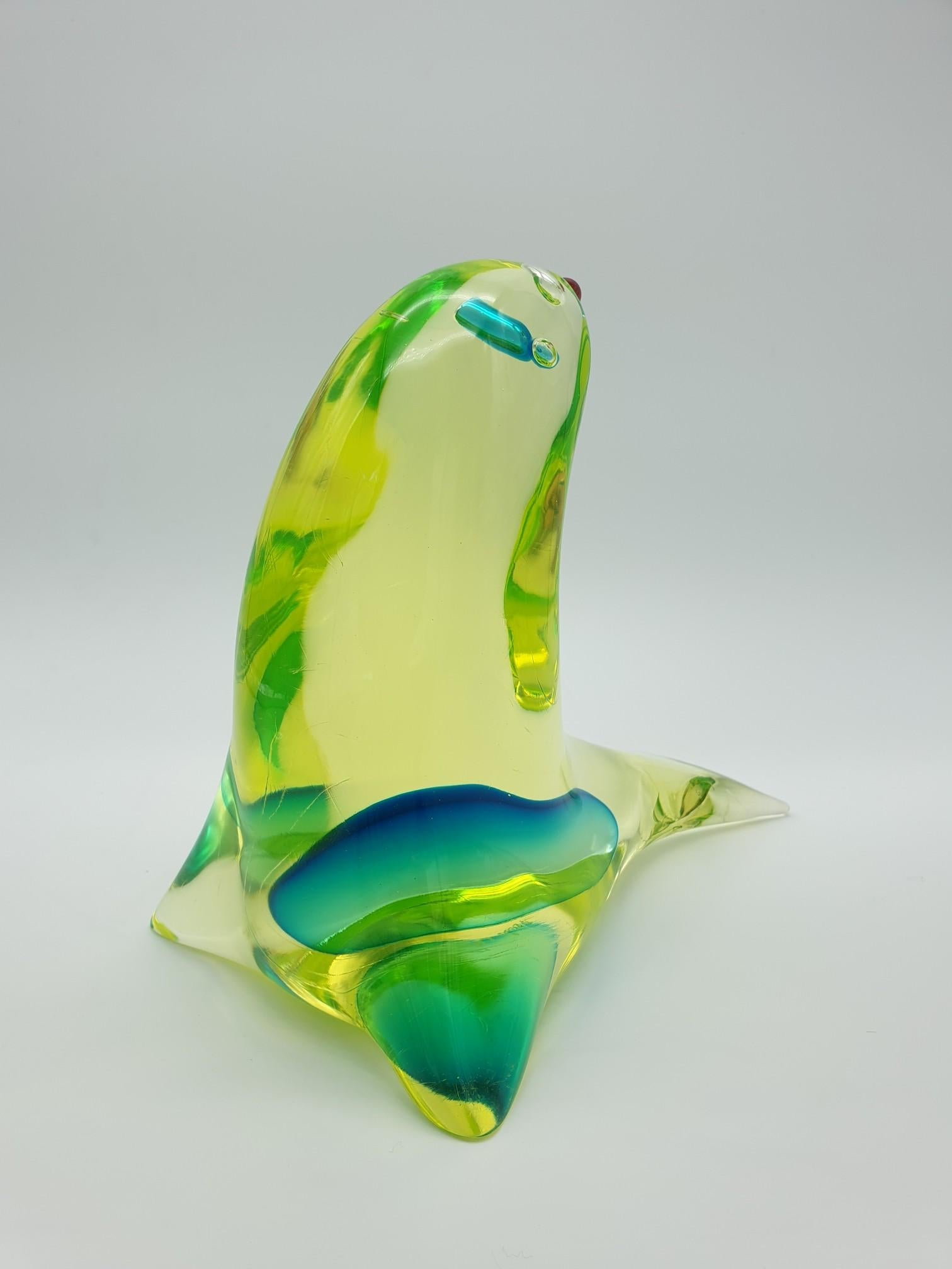 This cute baby seal was made in the mid-1960s in Murano by the glass-factory Gino Cenedese e Figlio and desigend by Antonio da Ros. The seal is made in vaseline yellow glass, with a splash of vivid turquoise color, and detailed with matching