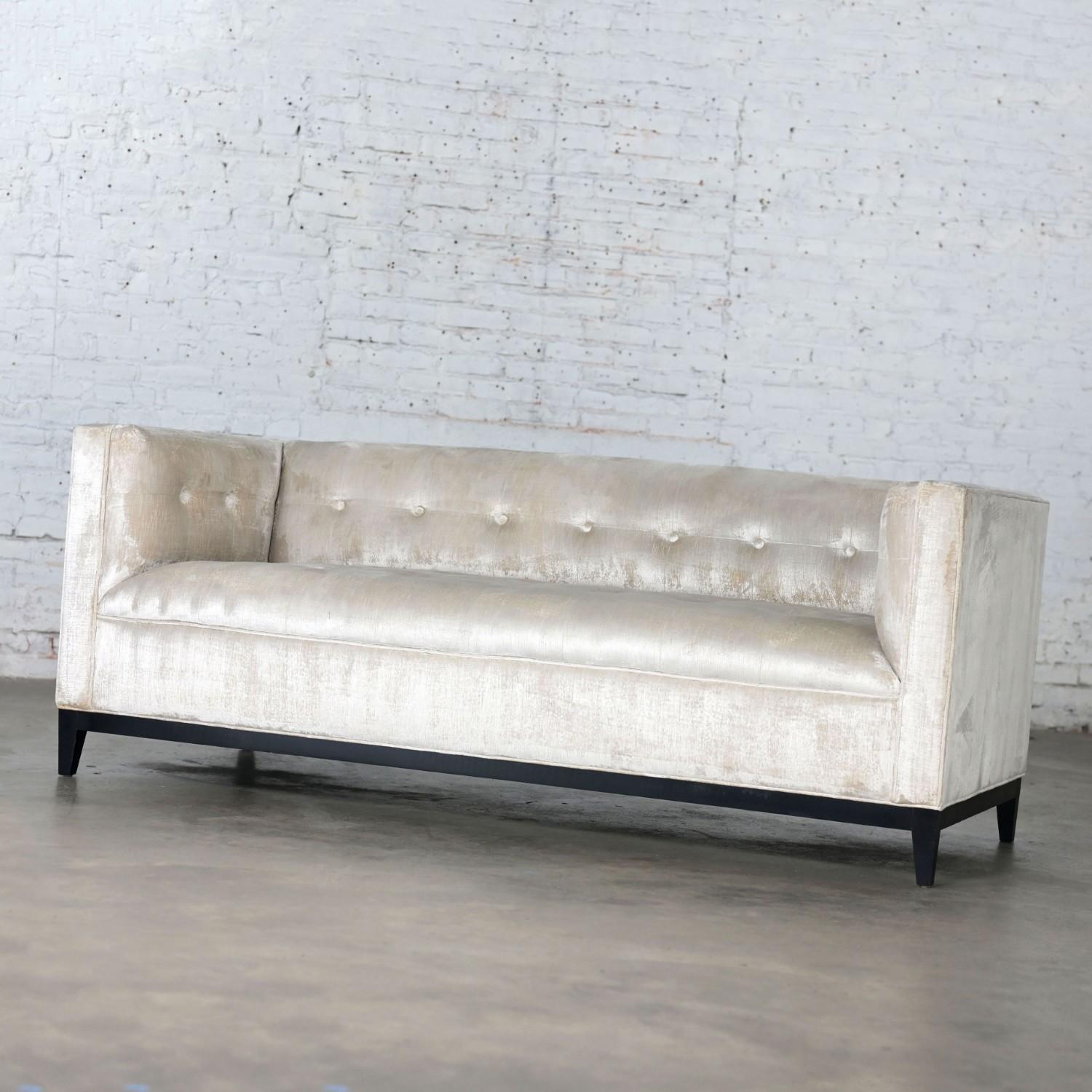 Magnificent vintage Modern tuxedo style sofa with champagne velvet fabric, tight back with button detail, & a black painted wood base with straight tapered square legs. Beautiful condition, keeping in mind that this is vintage and not new so will