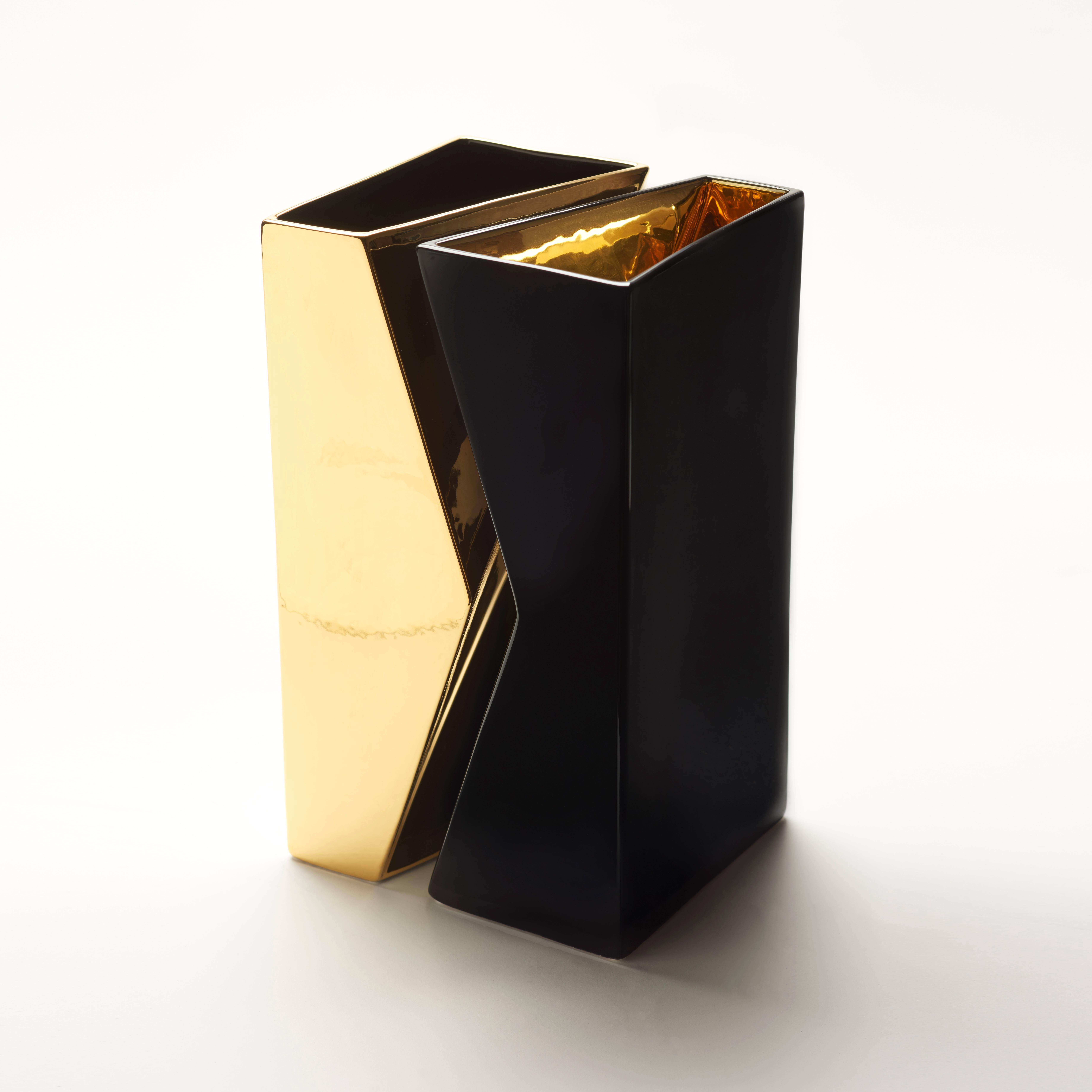 Pair of vases black with gold inside and gold with black inside, in ceramic, essential geometry, pure and unique forms, represent the direction. The separation or the union is defined by color. Separated or united, as well as they can contain