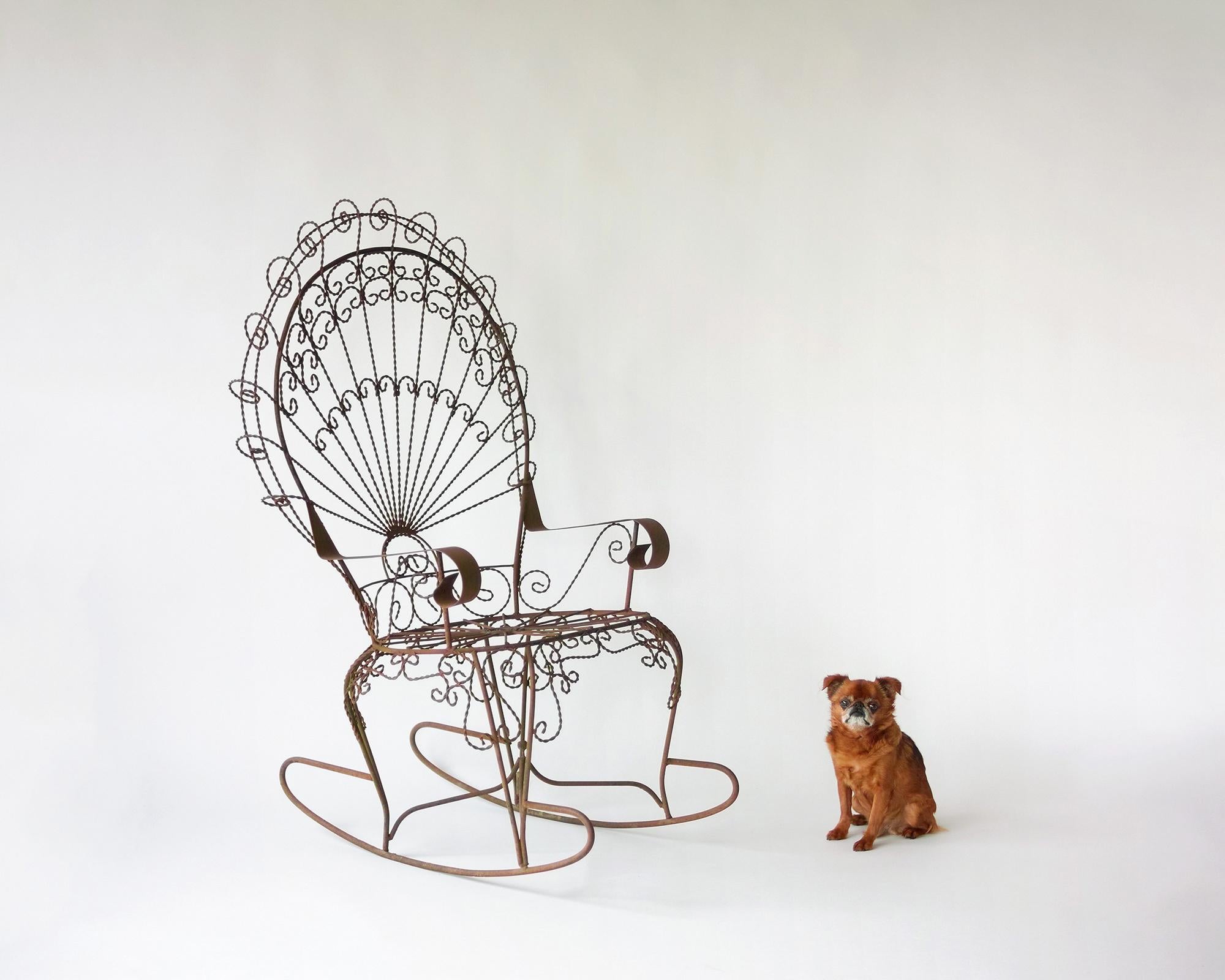 For your consideration is this all-original Peacock rocker by Salterini with a great aged patina, composed of twisted, curled, and welded wrought iron wire. A fun and dramatic place to sit, in this less common rocker variation of the Salterini