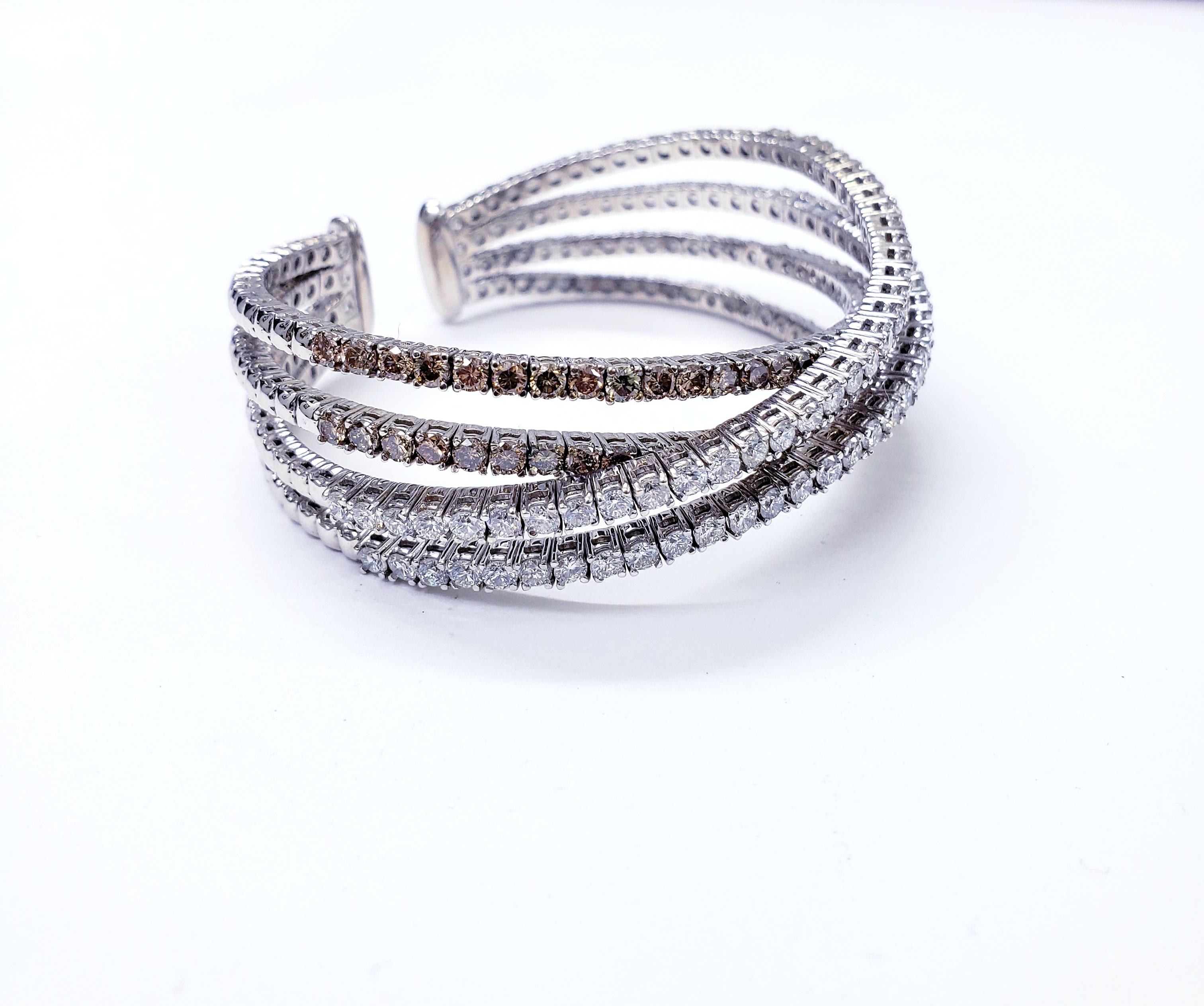 Modern Vintage Incredible diamonds bangle in 18k white featuring a total of 8.00TCW VS white and champagne diamonds.