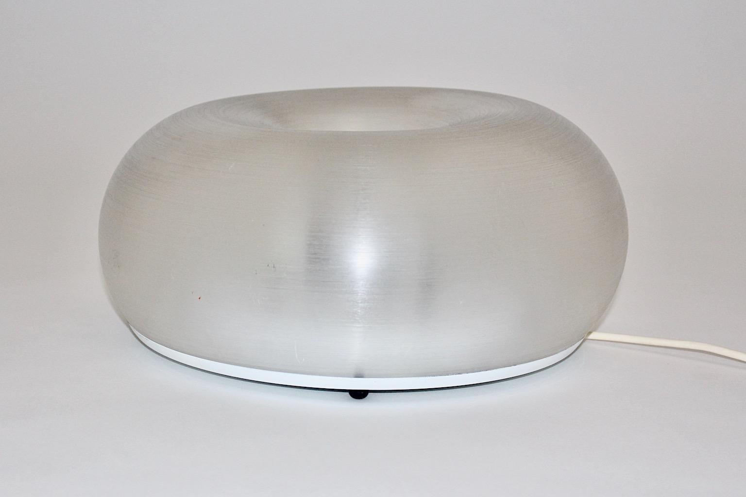 A modern vintage Lucite plexiglass table lamp or sconce, which was designed in Italy, 1980s.
The table lamp or sconce features a round shaped plexiglass shade with chromed metal details, a chromed metal disc deepens in the middle of the lamp.
2 E
