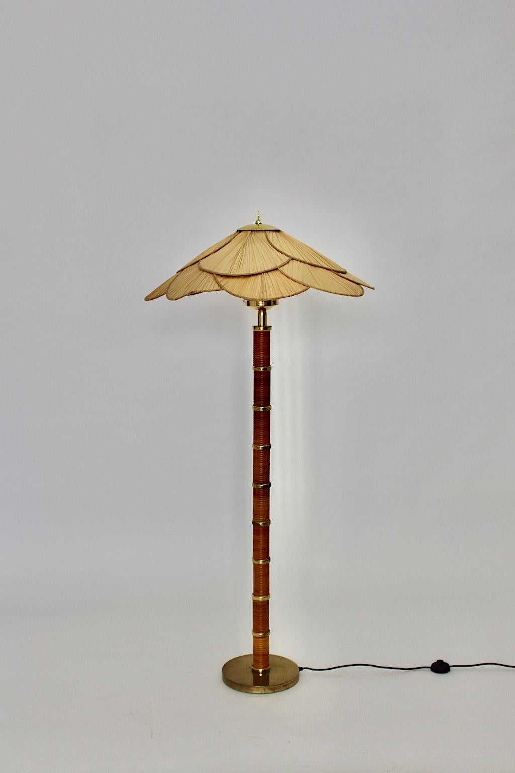 Modern vintage floor lamp from rattan, brass and opal glass 1970s Italy.
A classy floor lamp with a rattan stem, brass details and an opal glass shade with palm leaves shade in an amazing form.
The lollipop-like opal glass, sitting on the top,