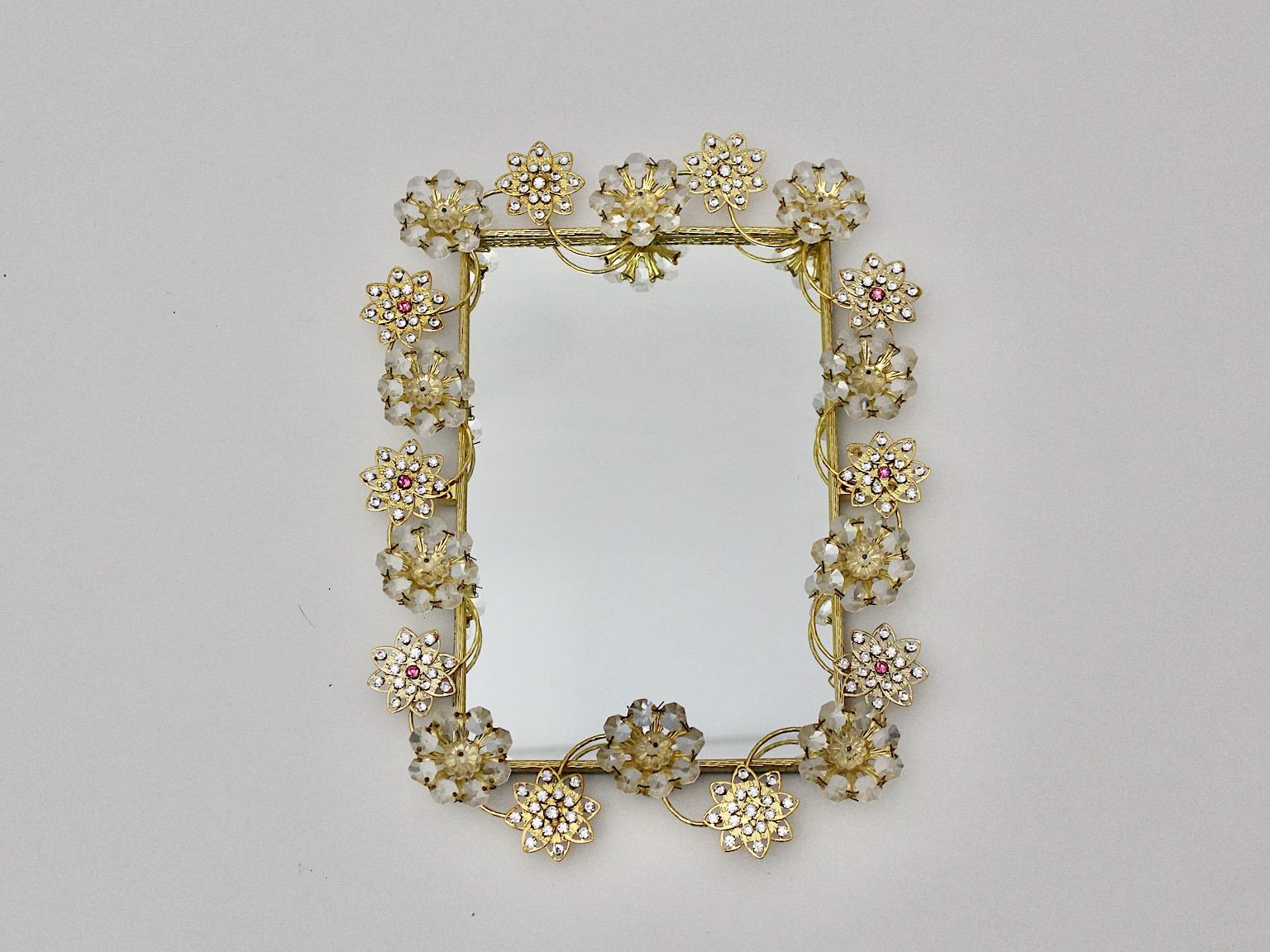 Modern vintage golden metal wall mirror in rectangular shape with glass stones flower and stars like 1990s, Italy.
Charming wall mirror framed with decor, which shows flowers and stars like arranged clear glass stones with few soft pink glass