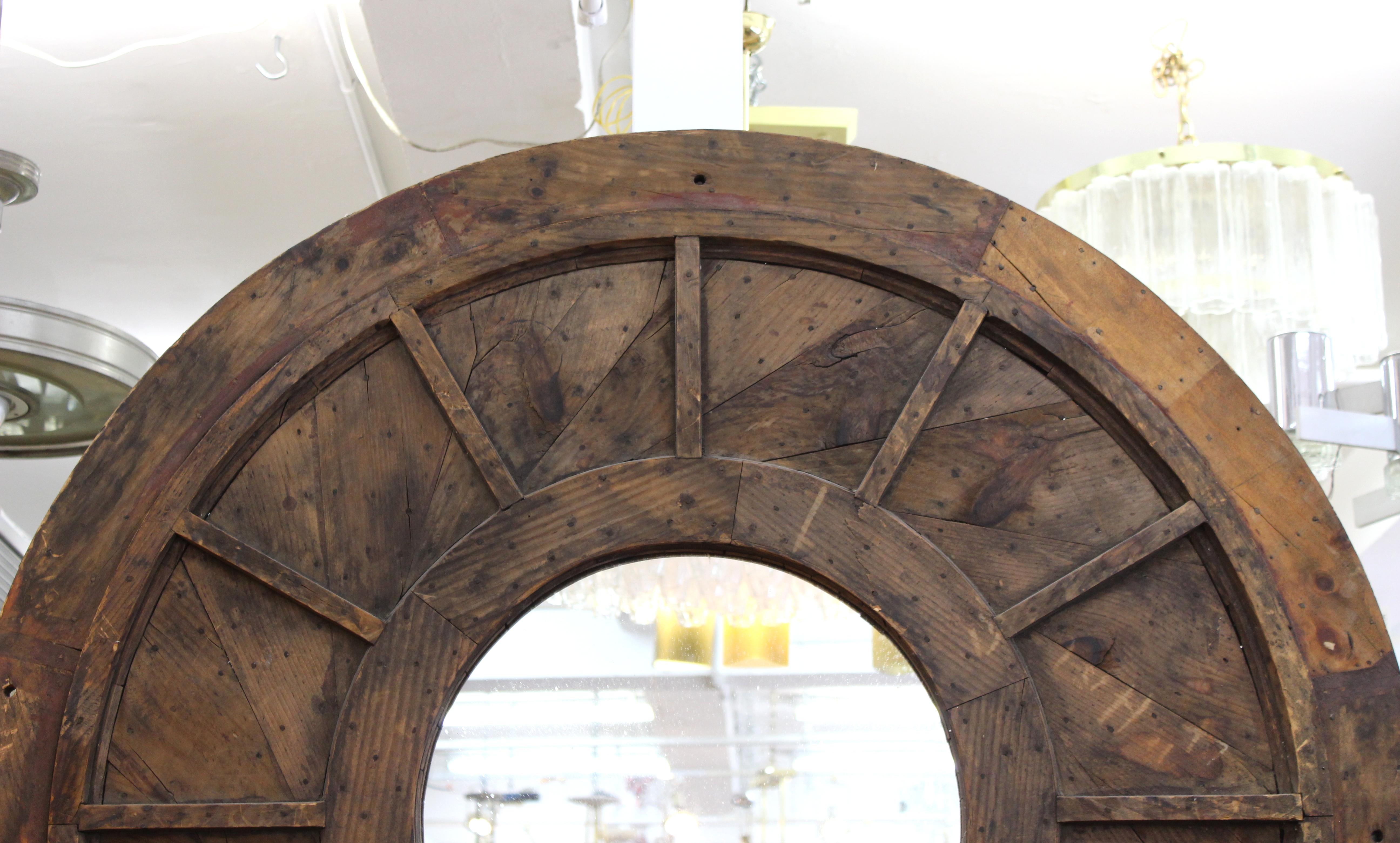 Modern vintage style monumental round wall mirror in reclaimed wood.