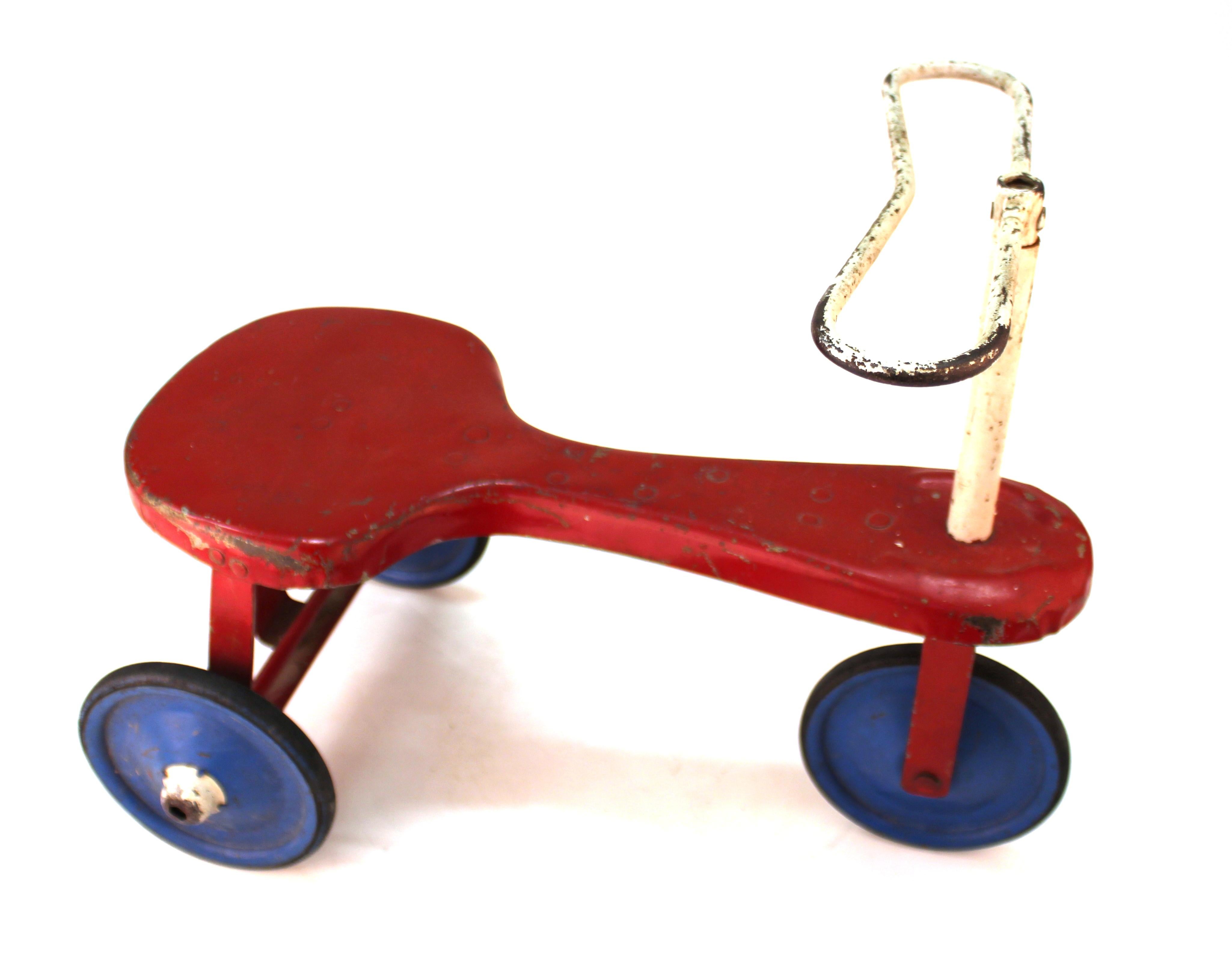 Modern period vintage toy tricycle, made in the 1940s. The item has a metal frame and its original rubber wheels. The piece is in great vintage condition with rustic wear to all surfaces.