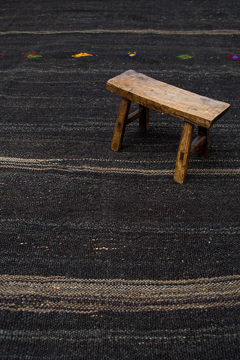 A Minimalist approach with this vintage wool and goat hair Kilim with hand-embroidered tribal motifs.
  