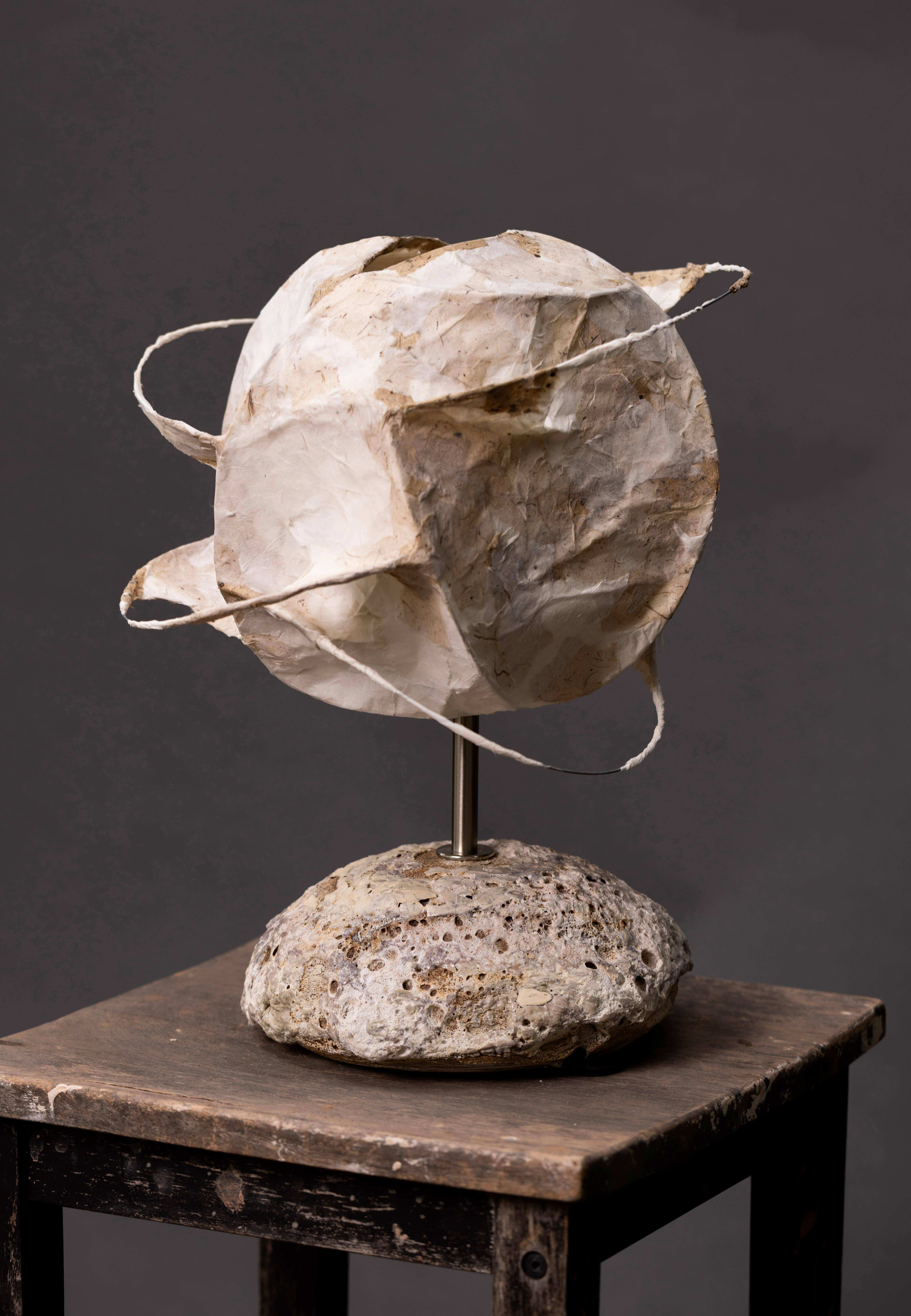 This handcrafted ceramic lamp is a striking fusion of artistry and function, featuring a sculptural base adorned with a richly layered volcanic glaze. The surface evokes the tactile beauty of raw earth, echoing cratered textures, natural stone, and