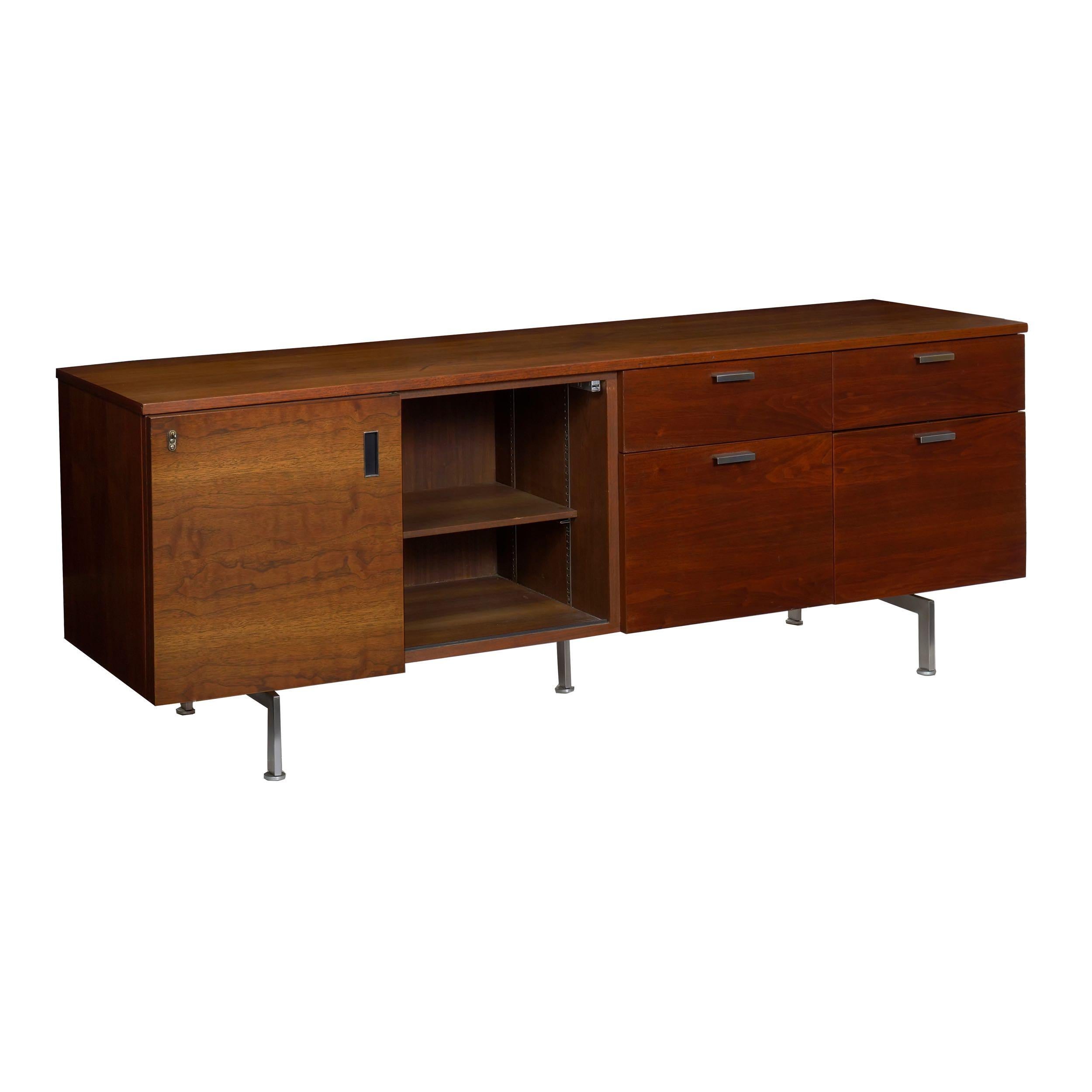 A sleek and interesting credenza that couples organic walnut with its wild chaotic grain against a matte welded steel base and molded pulls, it was designed and executed by the firm of Robert John 