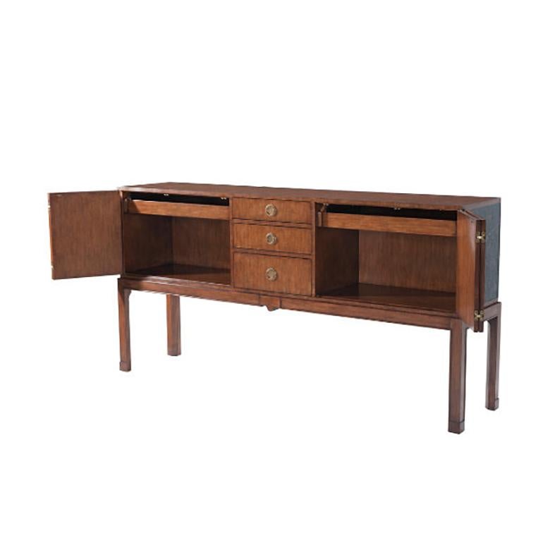 A Pacific walnut veneer buffet, the rectangular top above a central bank of three graduated drawers, flanked two each side by a Chinoiserie painted and black canvas wrapped double hinged door, each enclosing an open drawer and an adjustable shelf