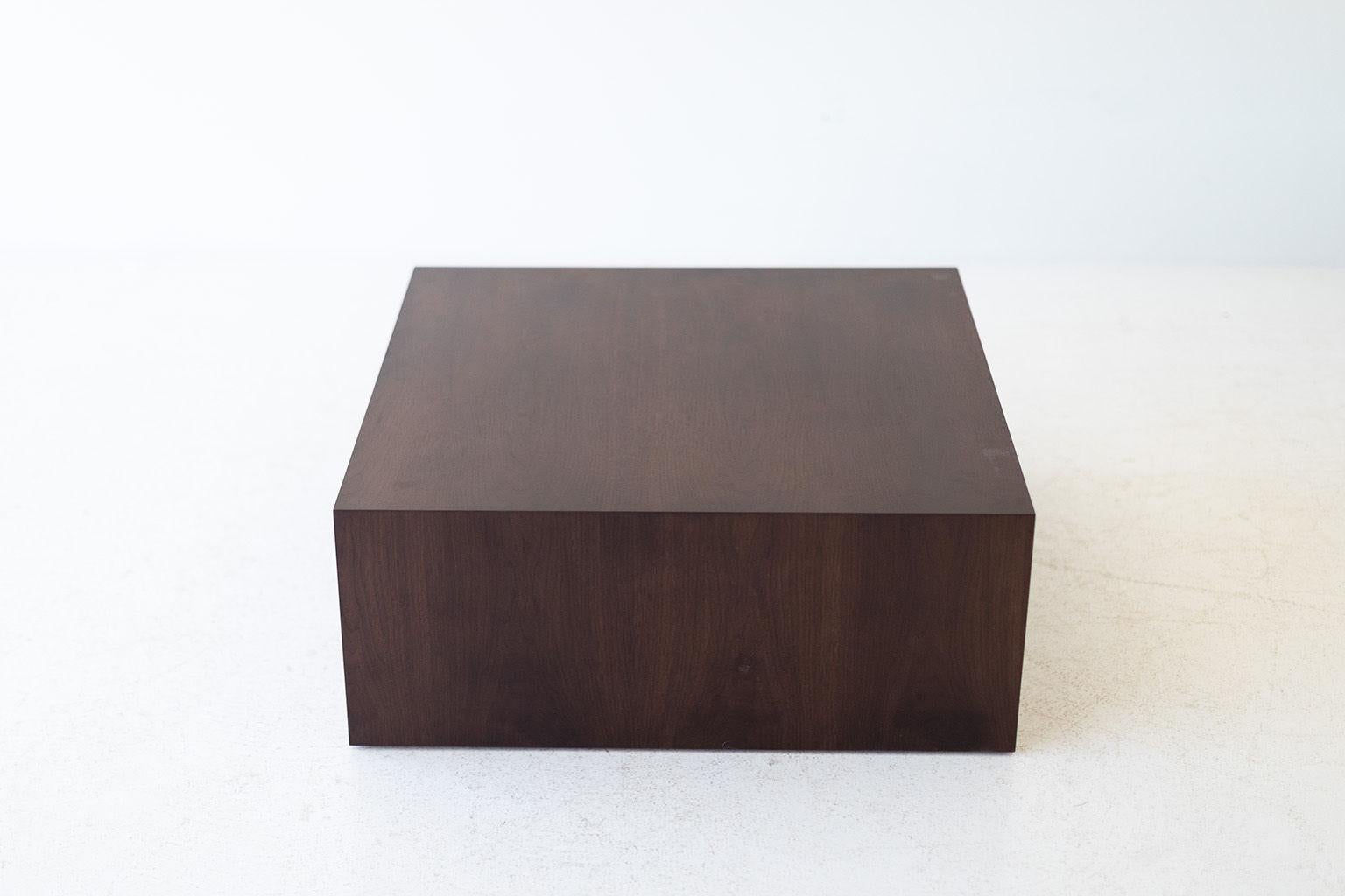 This modern walnut coffee table is made in the heart of Ohio with locally sourced wood. Each table is a hand-made mitered box from walnut veneer and finished with a beautiful matte commercial-grade finish. These are made to order so you can