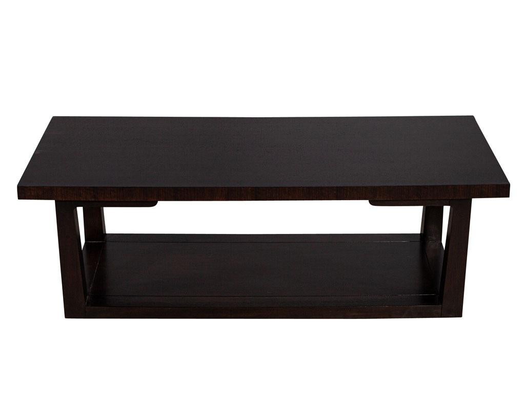 Modern Walnut Coffee Table in Espresso Finish. Minimalist design with storage shelf underneath. Finished in a rich satin espresso stain. New, made in the USA and custom finished at Carrocel. Composed of walnut solids and veneers. Excellent storage