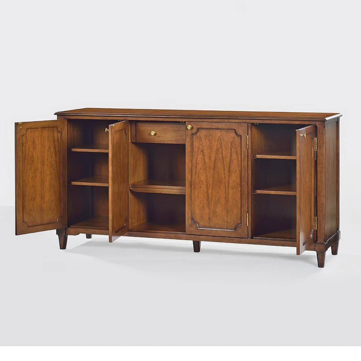 A modern walnut finish buffet with a smooth top, four doors with portrait profile, one large interior drawer, OGEE top edge, routed corner detail on the buffet sides and legs, has a “rustic” warm brown finish with subtle visual distressing and