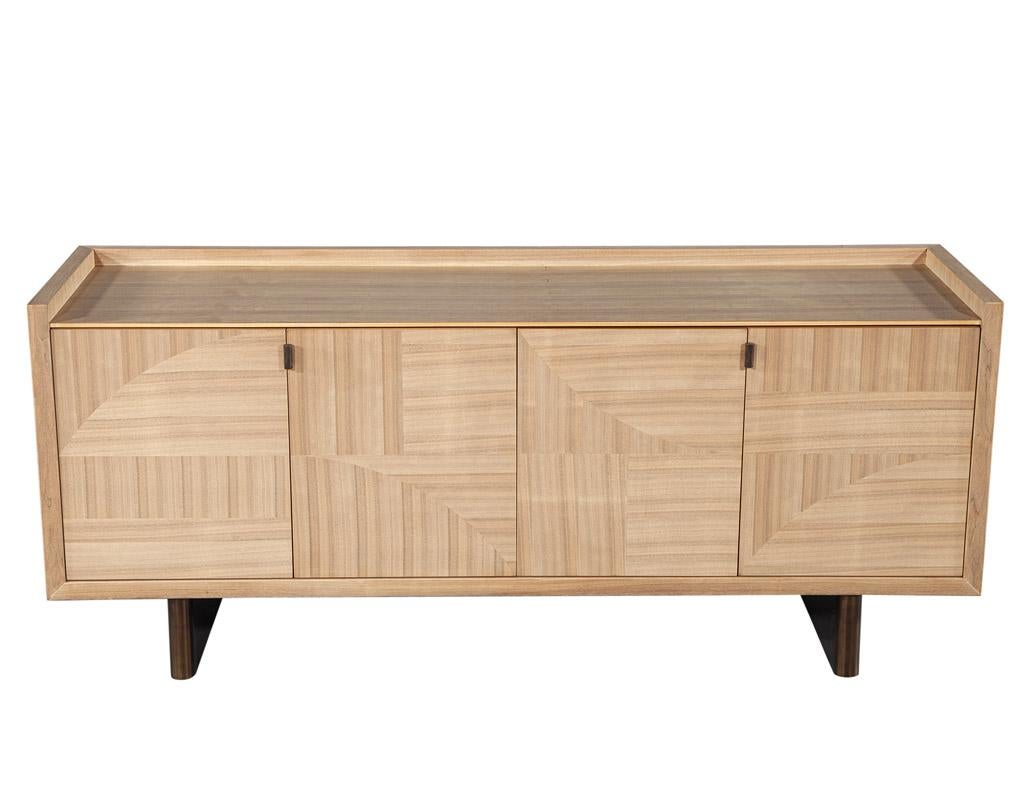 Modern Walnut Marquetry Sideboard in Natural Finish by Baker Furniture. This modern sideboard buffet from Baker Furniture is a stunning piece of furniture. The walnut wood is detailed and crafted with precision and the marquetry inlay front brings a