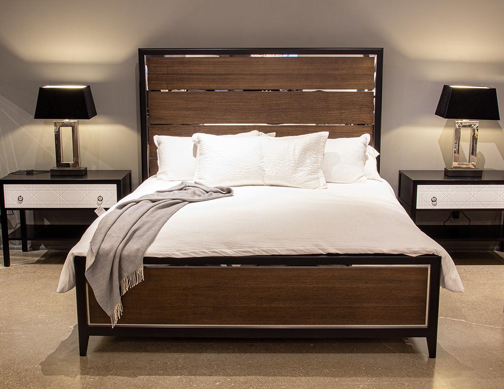 Modern walnut panelled bed with polished stainless-steel accents. Beautiful rich satin walnut finish with satin black lacquered accenting. Completed with inlaid polished stainless steel. New, made in the USA. Footboard Height 24”, Side Rails Height