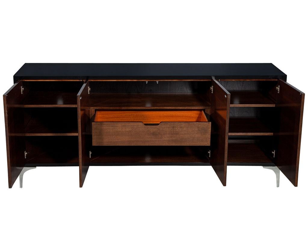 Modern Walnut Sunburst Sideboard Buffet Credenza. Featuring stunning hand polished black lacquer finish with dark walnut sunburst fronts. Completed with sleek polished stainless-steel feet. Interior has ample storage options with 4 adjustable