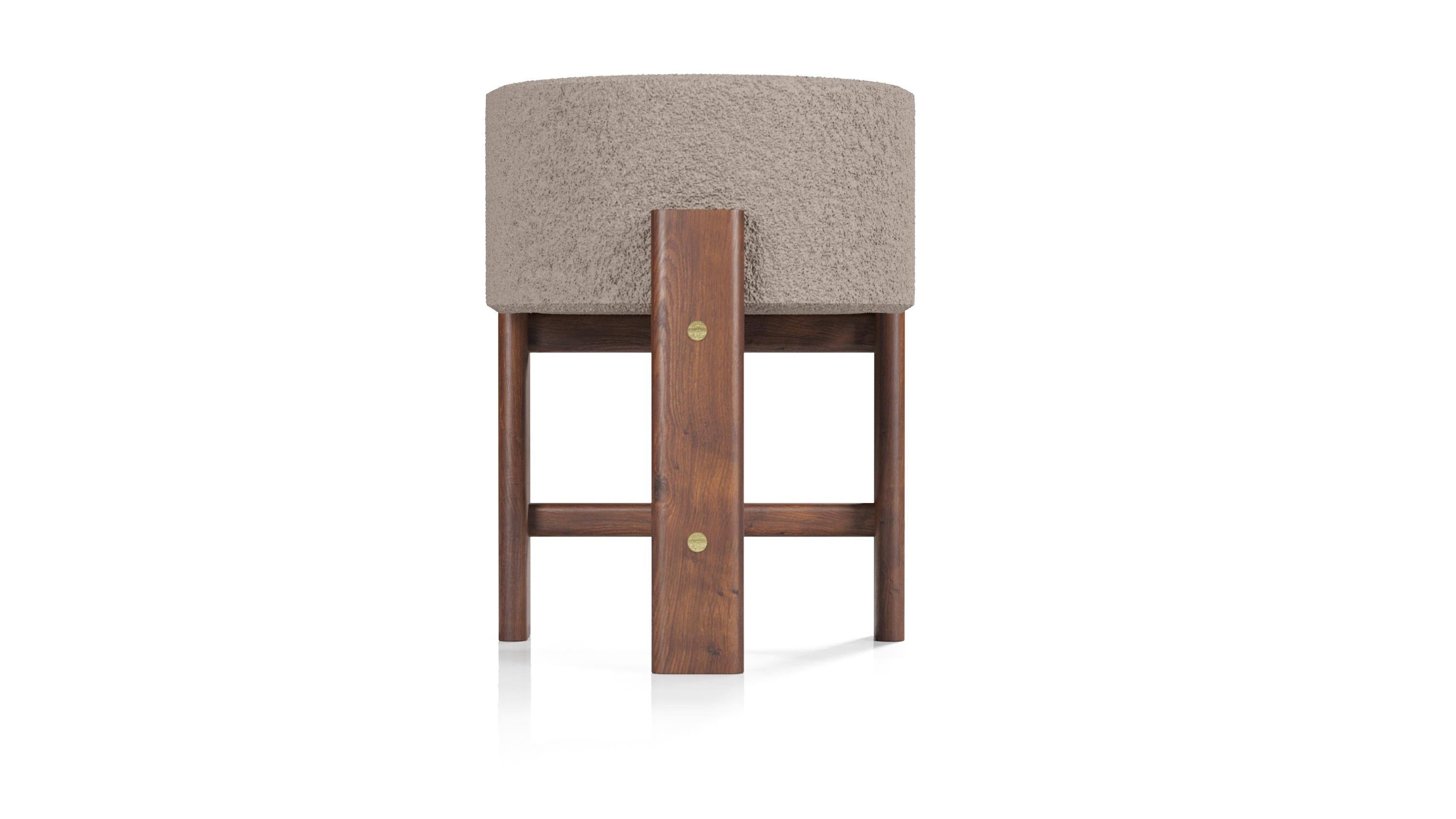 The Modern Malta barstool designed by Egg Designs and manufactured in South Africa. 
This Modern style dining room chair has a solid Walnut timber frame with solid brass details. It is upholstered in a very on trend charcoal Boucle'. Various fabric