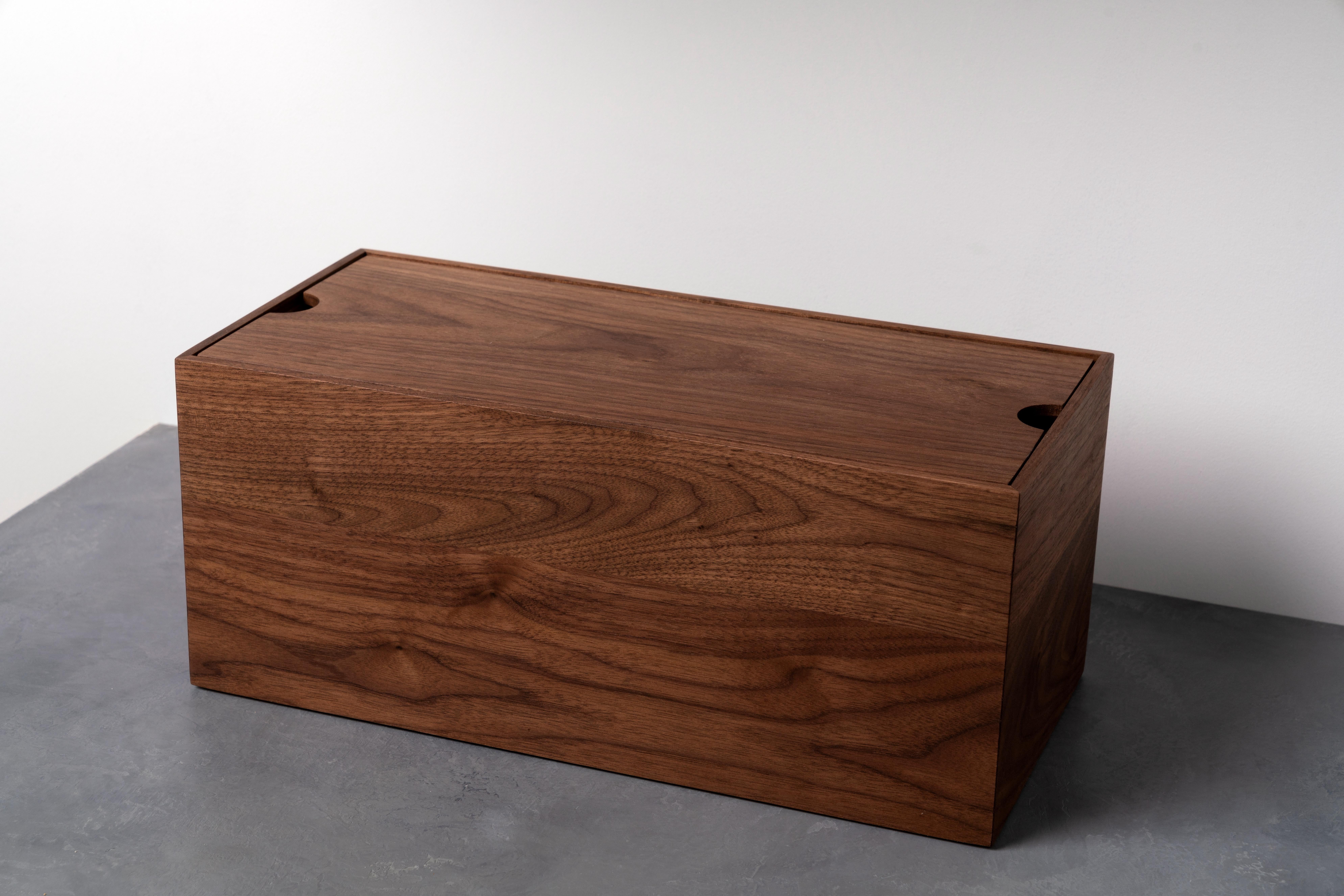 This handcrafted Modern Walnut Wood Bread Box will add a warm touch to your kitchen while keeping your bread fresher for longer. The flush lid doubles as a cutting board and features finger holes on either end for easy opening and airflow to keep