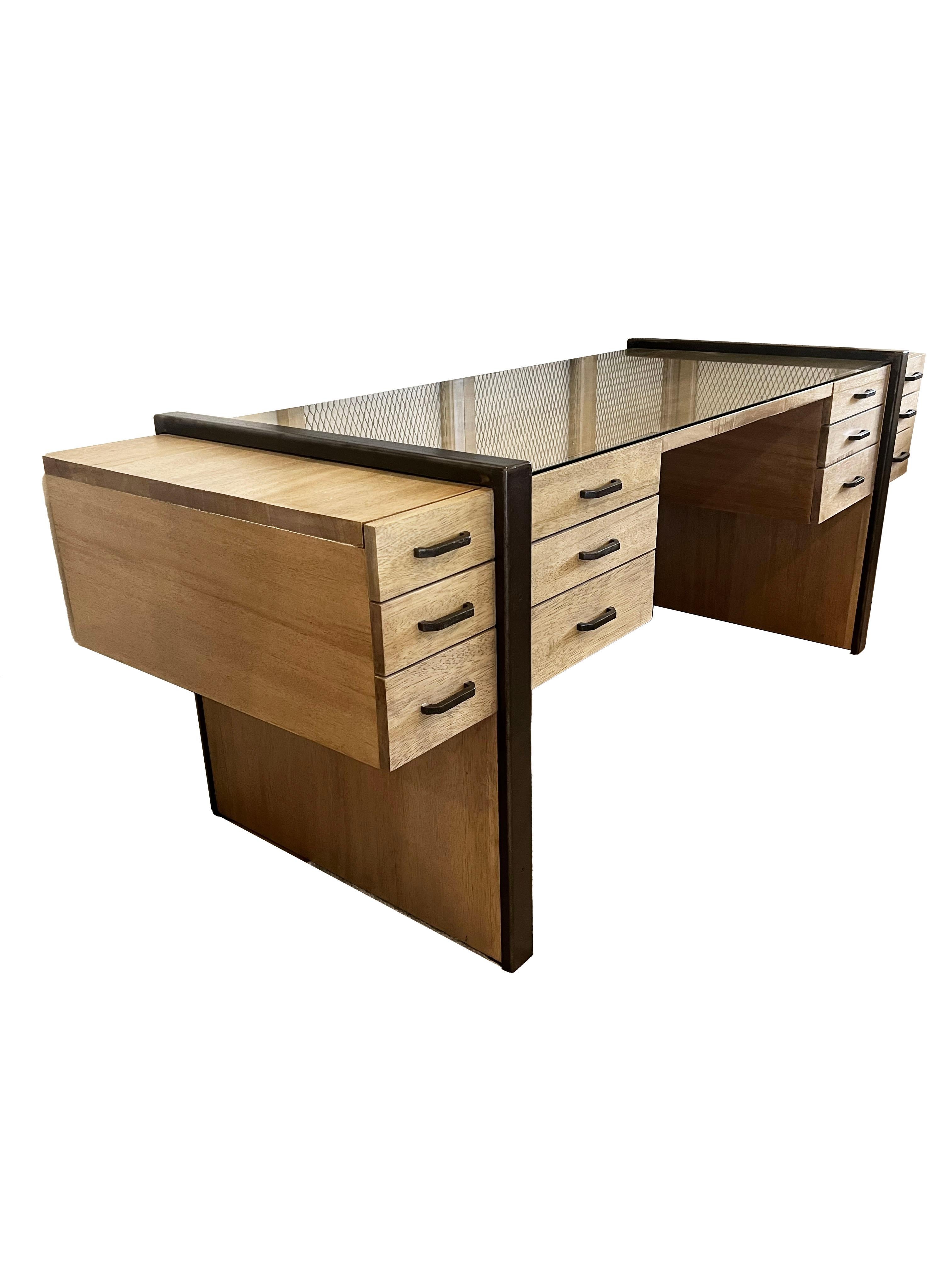 Modern Washed Walnut Desk by Noir Furniture. Boasting a unique and stunning silhouette, this desk features twelve drawers on glides, each adorned with hammered iron drawer pulls, adding a touch of industrial charm to its sleek profile. The
