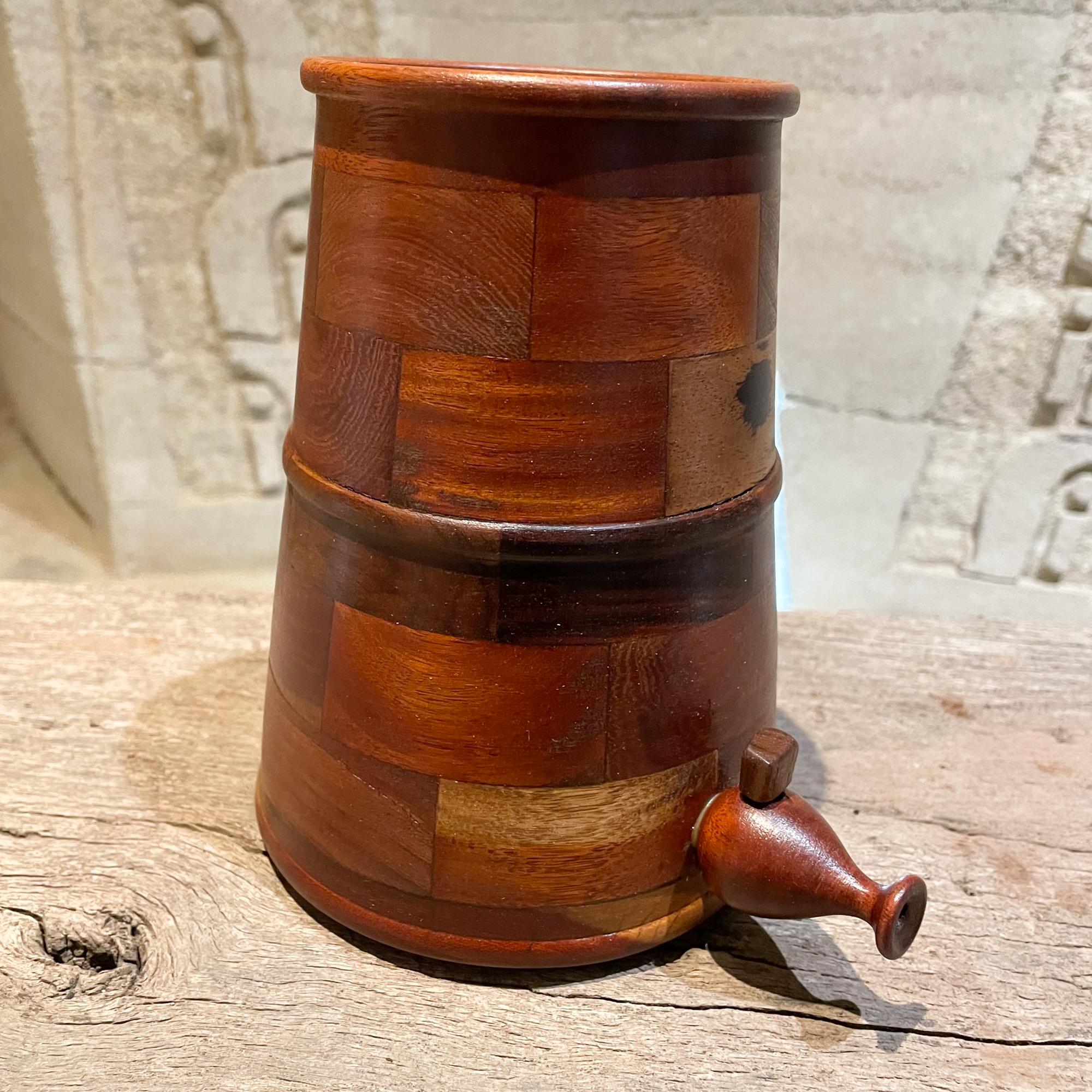 Handcrafted modern beverage jug cooler dispenser in turned wood manner of Don Shoemaker Mexico, 1970s
Unmarked. 
Exquisite wood grain pattern.
Measures: 7.25 height x 5.5 Diameter x 7.25 depth inches
Original preowned vintage modern piece. Good