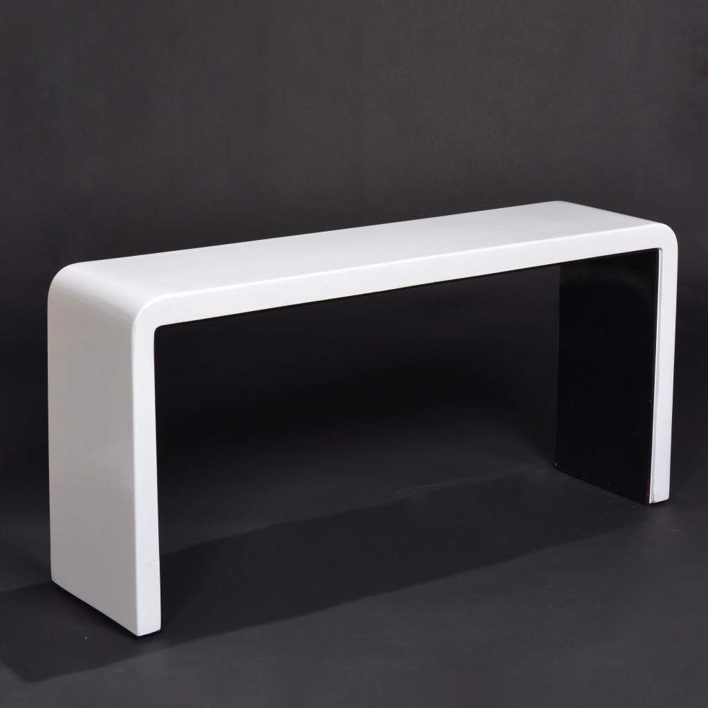 White lacquered Post-Modern waterfall console table featuring curved corners, clean lines, and a sleek black underside.