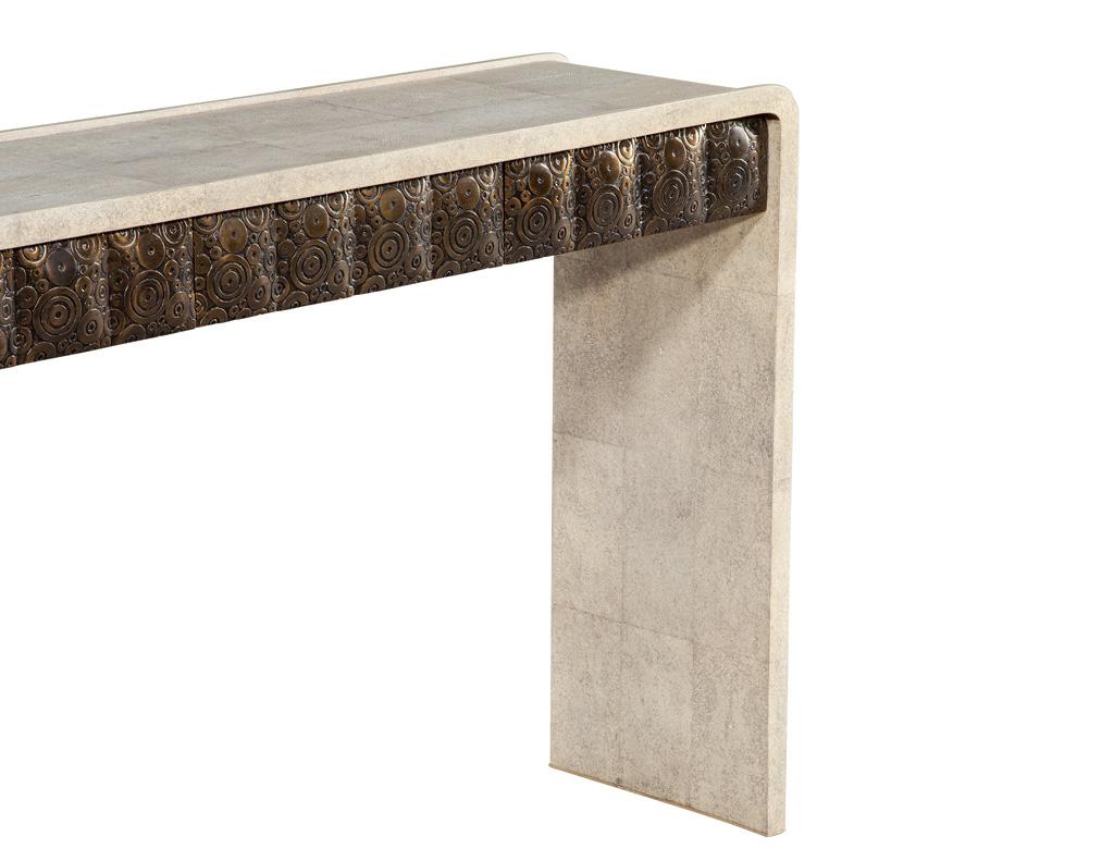 Introducing the Modern Waterfall Console, a stunning addition to any contemporary living space. This elegant piece showcases a sleek waterfall design that gracefully flows from top to bottom, creating a sense of sophistication and fluidity. Wrapped