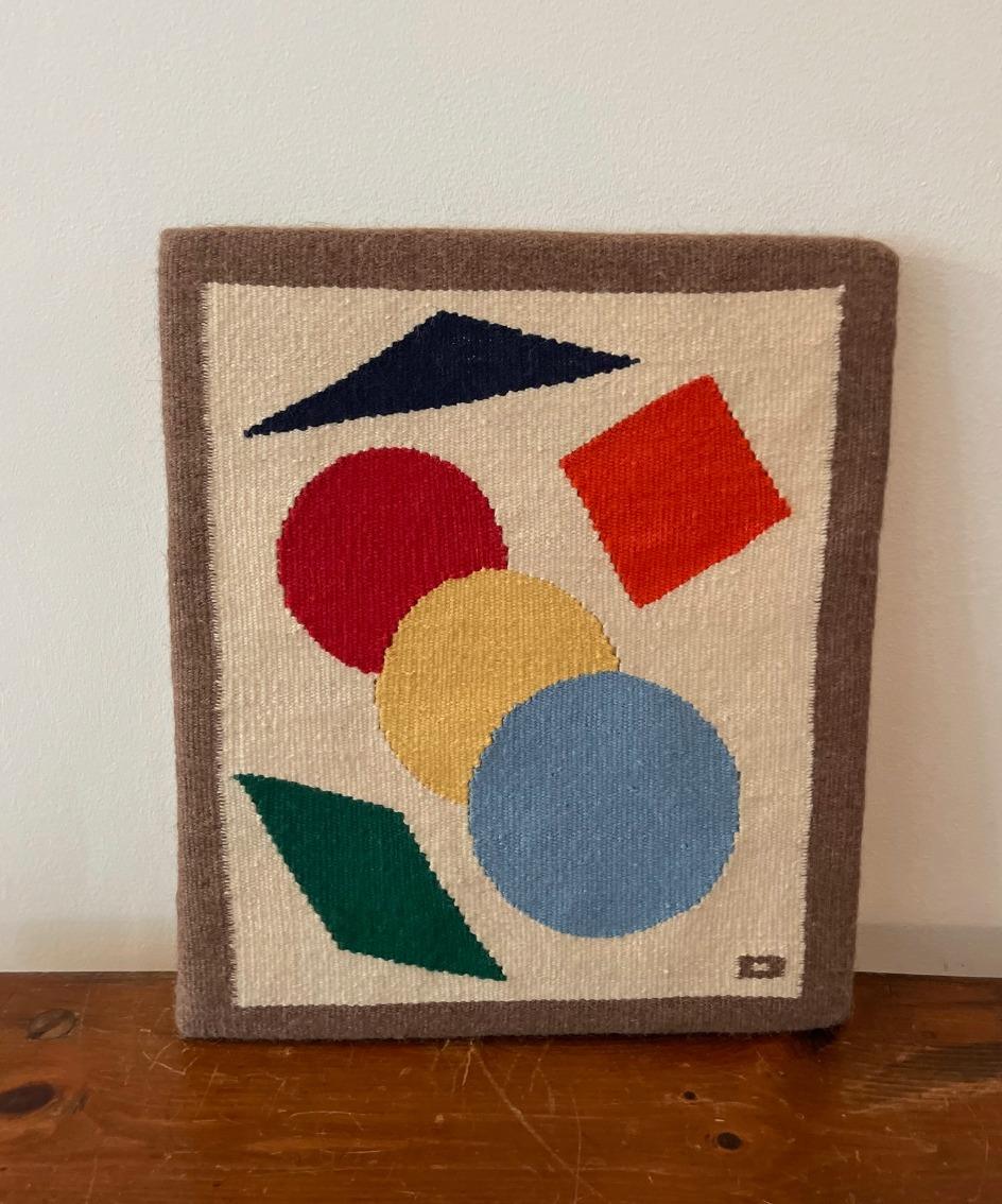 Modern weaving by artist Dick Bailey. Shapes that captivate the imagination. Custom hanging hardware on back along with artist description.
