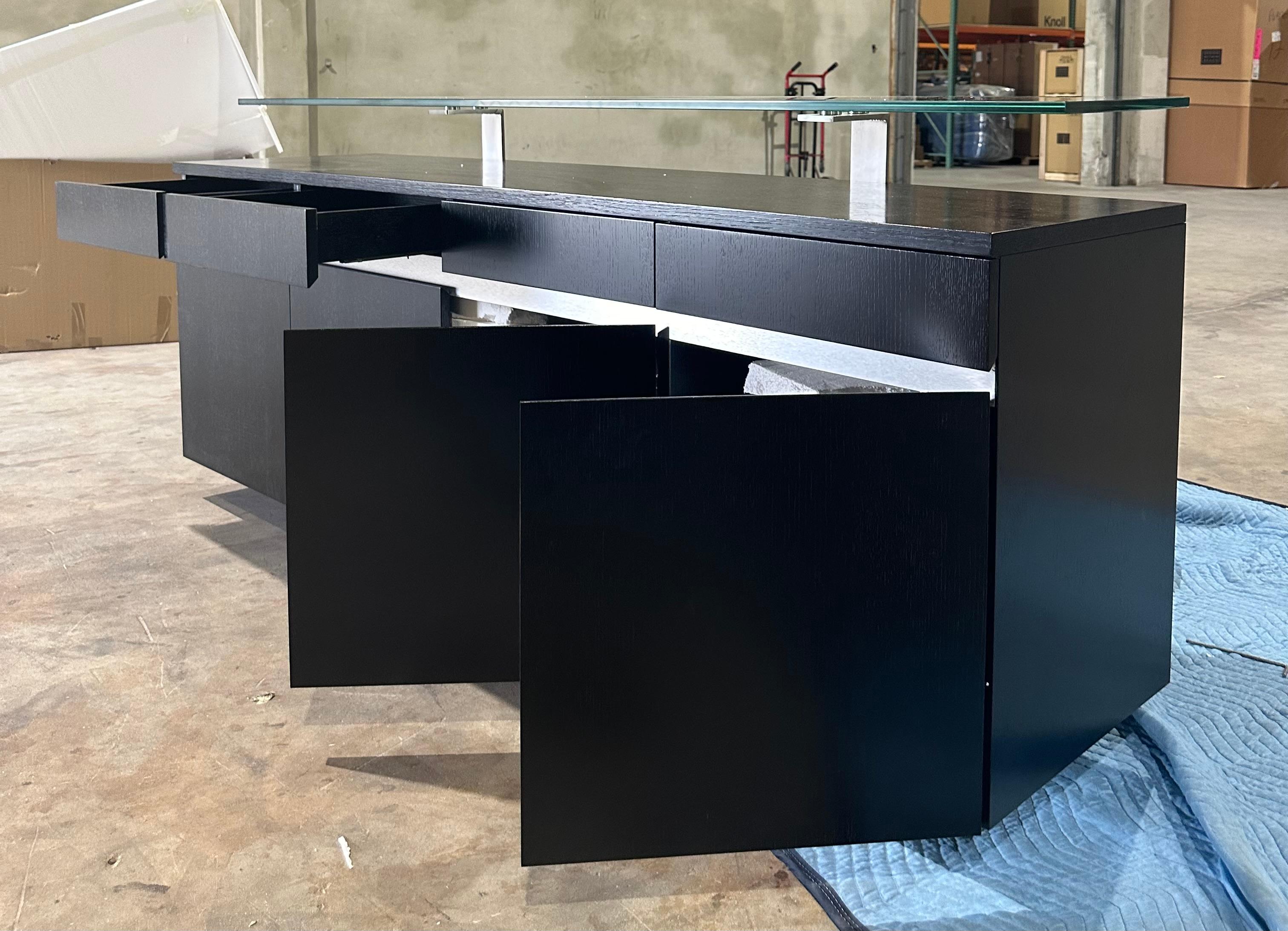 Modern Wenge buffet with floating glass top designed by Greg Sheres.  In stock.  Impressive statement pieces rarely come with as much function as the “Angles” Buffet does. This contemporary dining room essential features four drawers, four doors,