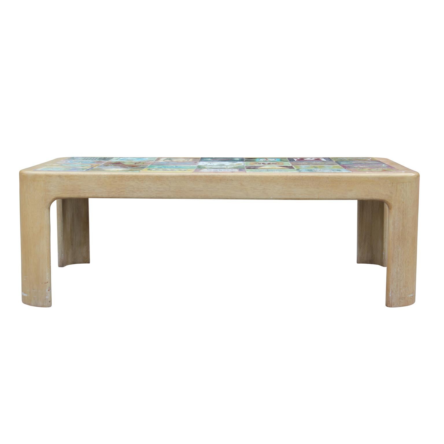 Whimsical coffee table with hand painted tiles in the style of Roger Capron. Would be an excellent statement piece in any room. Each tile is unique, circa 1960s.