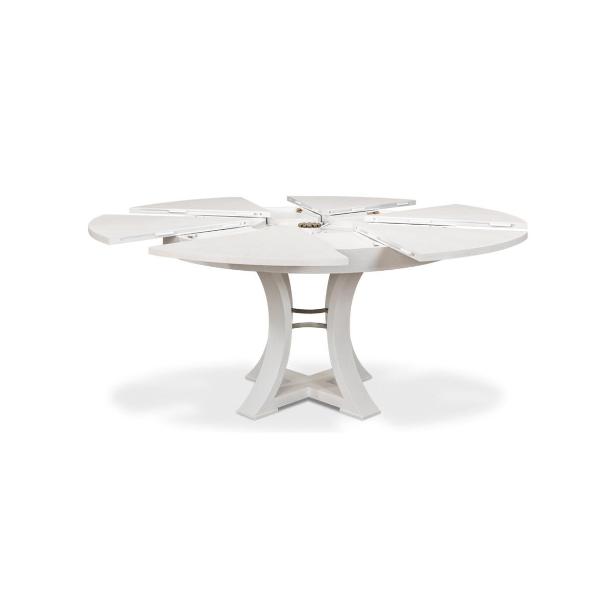 A modern round extending dining room table. Oak top in our working white finish with a simple geometric form base. The table opens and extends to 70