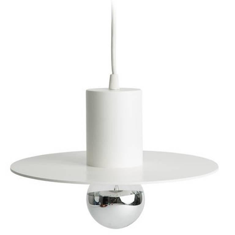 White pendant in the form of a hat with exposed bulb. Spun aluminum in white powder coat finish with white silk cord and coordinate canopy. Custom diameter and custom color finishes available. Mercury glass bulb included upon request. 

Influenced