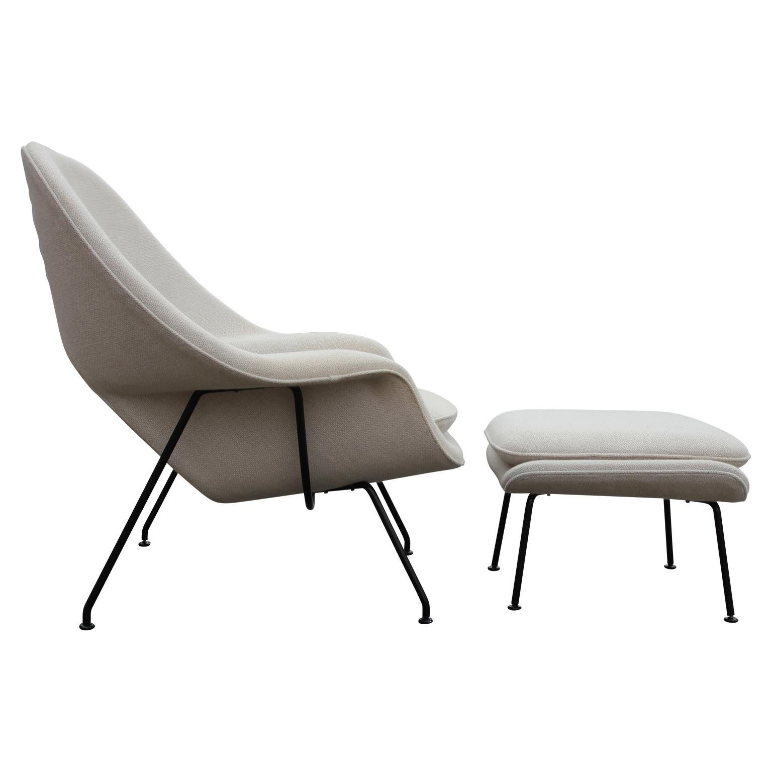 Modern white womb chair and ottoman designed by Eero Saarinen for Knoll. The chair still has the original wool fabric that is in decent shape.
- circa 1980s
- Black steel

Dimensions of ottoman: H 14 in x W 25 in x D 22 in.