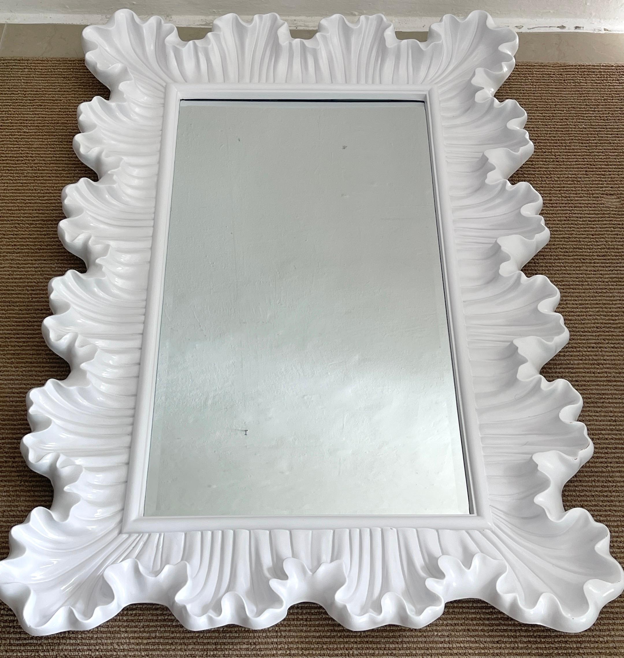 Modern white lacquered scalloped rectangular mirror, with continuous stylized shell scalloped white lacquered surround, with inset 18-Inch wide x 34-Inch high beveled mirror. 
 