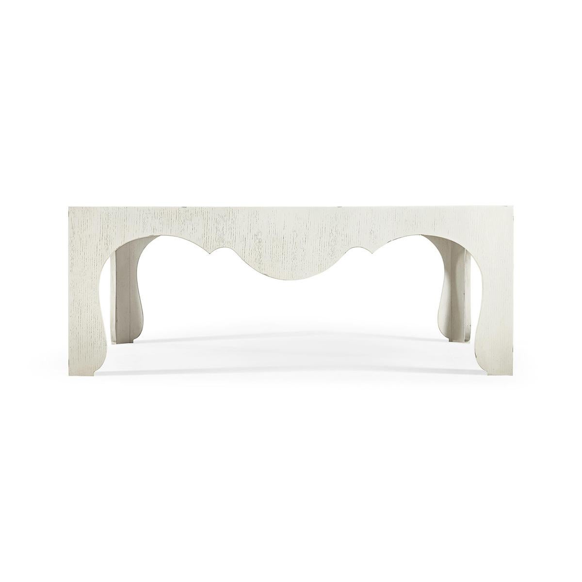 Crafted with artistic precision, this table features unique serpentine edges and subtle cut-out details that give it a flowing, organic appearance. The soft chalk white finish adds a modern touch, enhancing the table’s aesthetic while complementing