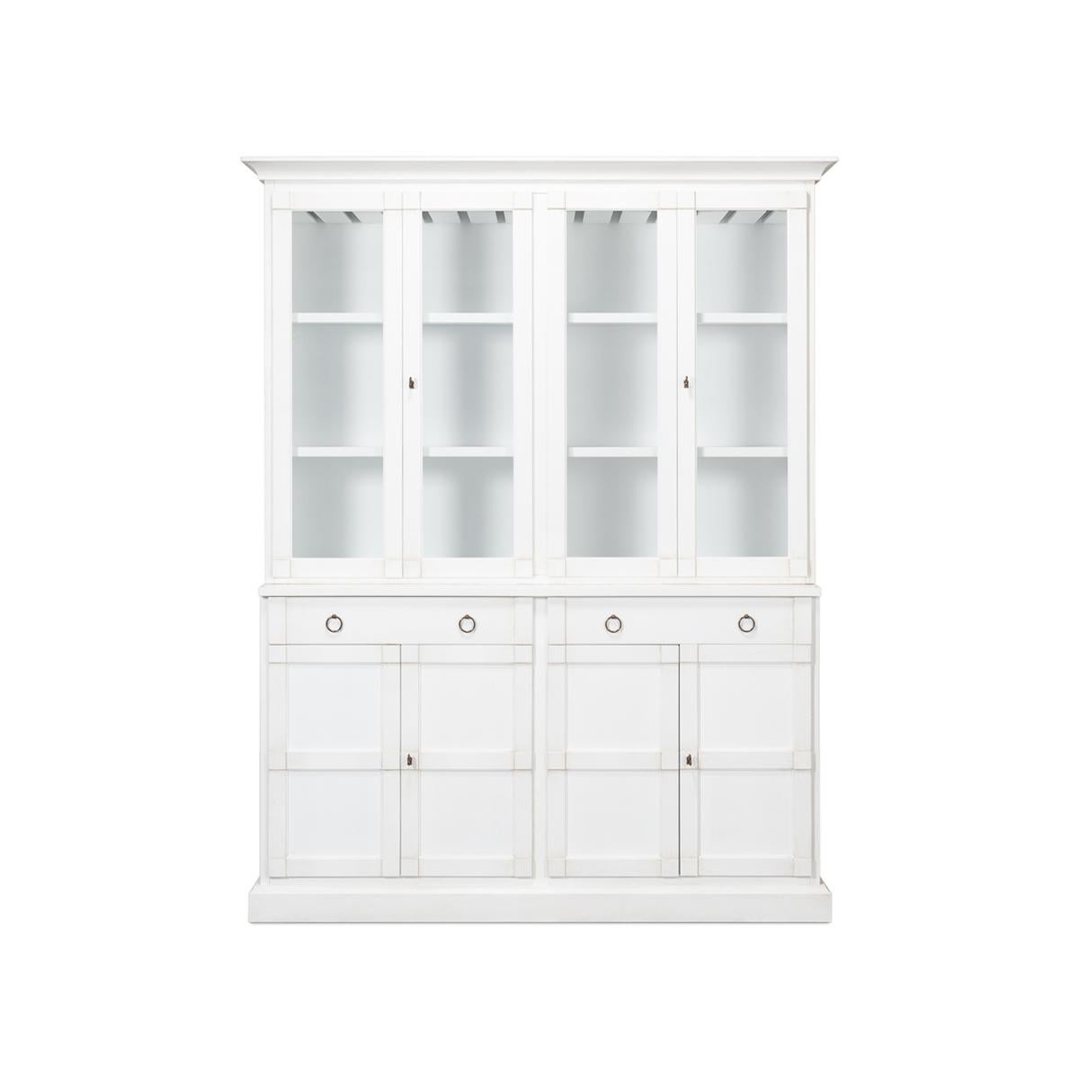 Modern white painted hutch, made of solid pine and painted in a bright solid white. The interior was fitted with wine racks, and drawers, with glass front doors, raised on a high wasted four-door lower cabinet with two drawers, and interior shelves,