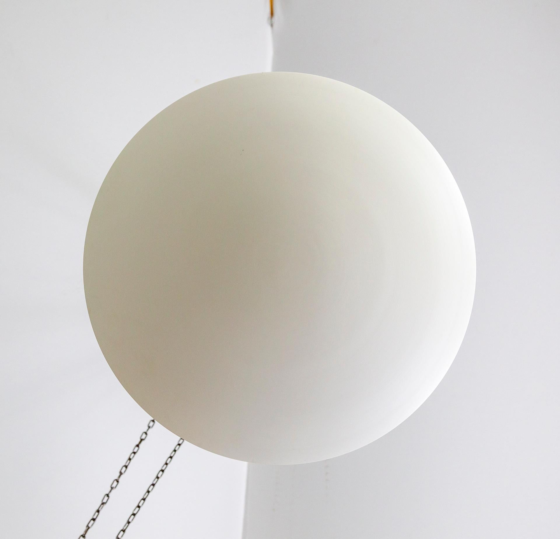 A matte-white, spun aluminum, convex disk up-light fixture in a minimal, modern design.  It hangs roughly 8 inches from the ceiling to cast a pleasing, diffused light.  It is versatile and complements many styles. Made in California by Nova