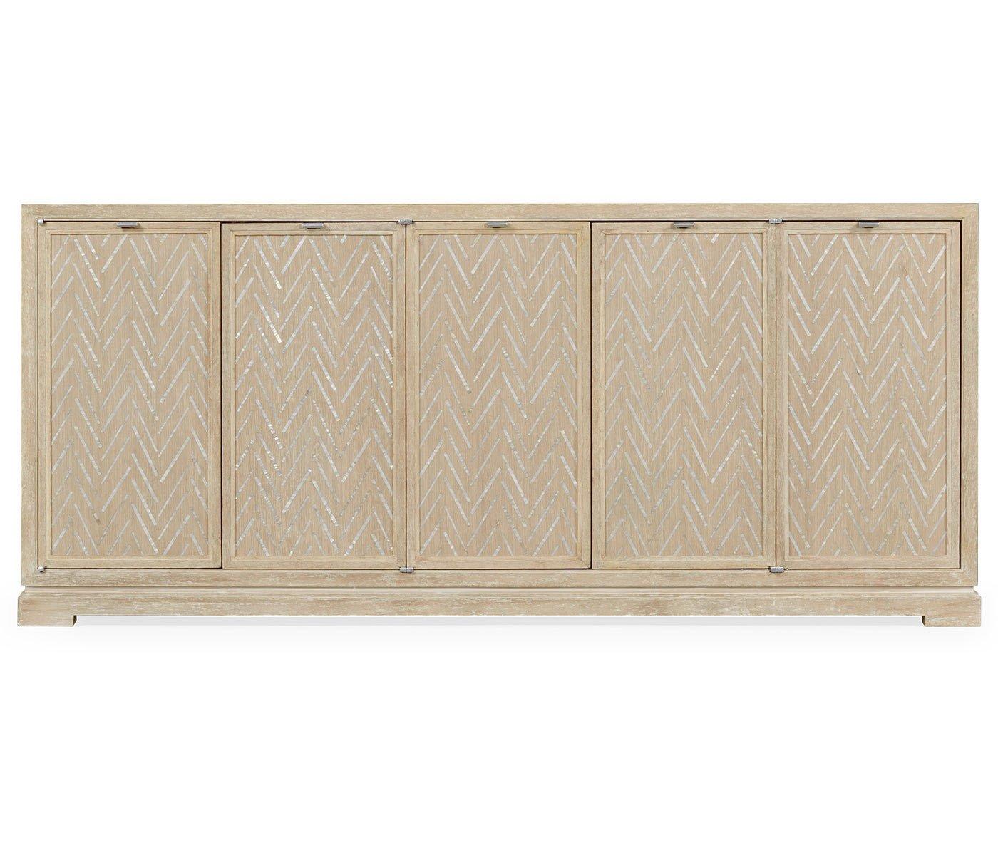 A unique modern whitewashed credenza with reversible front panels for different motifs. Beautifully inlaid mother of pearl Classic herringbone fronts, or custom hand printed Julian paisley, or any possible combination which makes 