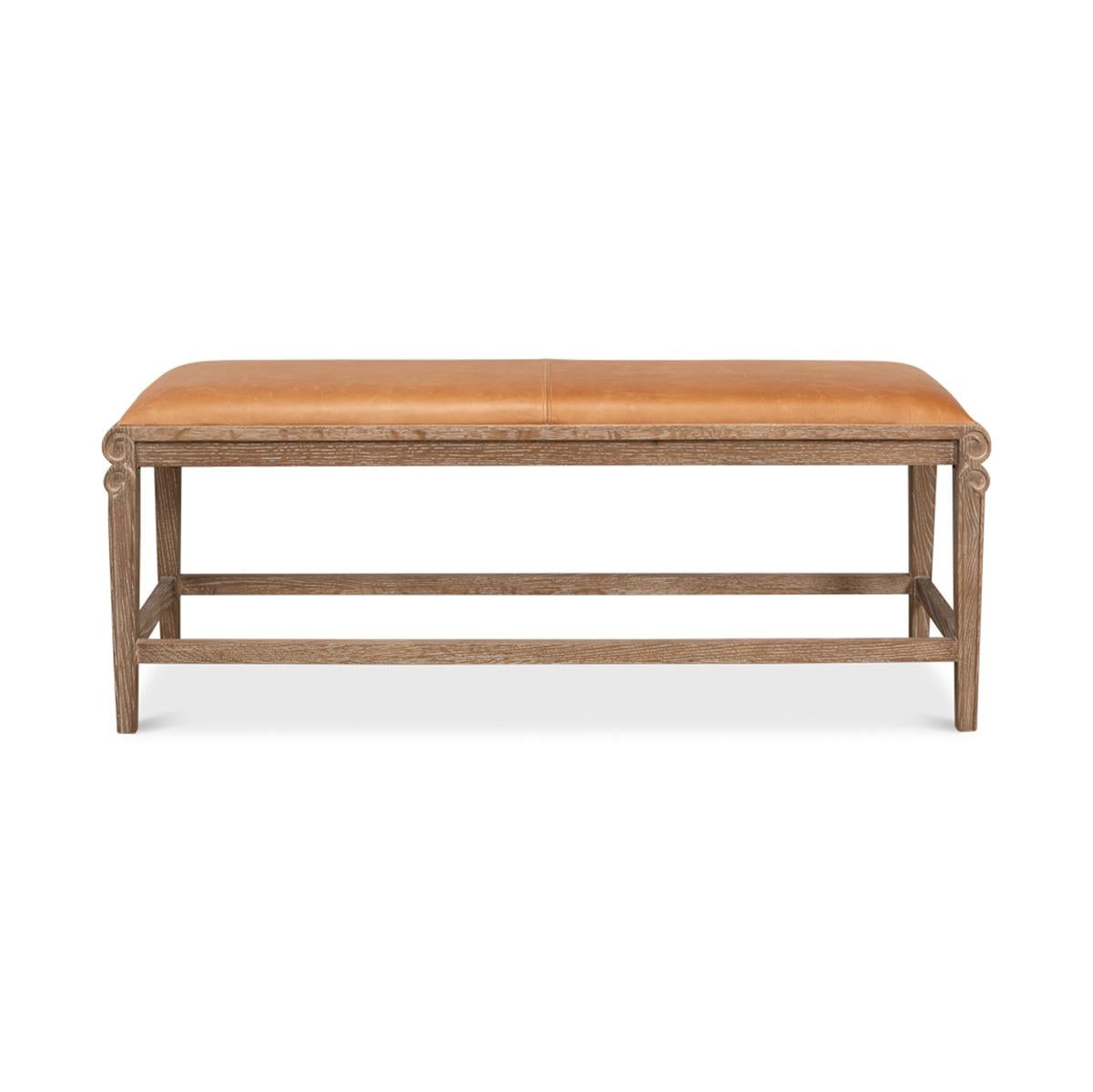 A modern whitewash and leather upholstered bench. This elegant bench has a tan leather cushioned top and sits on a whitewashed oak frame with graceful lines.

Crafted in neutral colors with a versatile design, this bench can easily be enjoyed in any