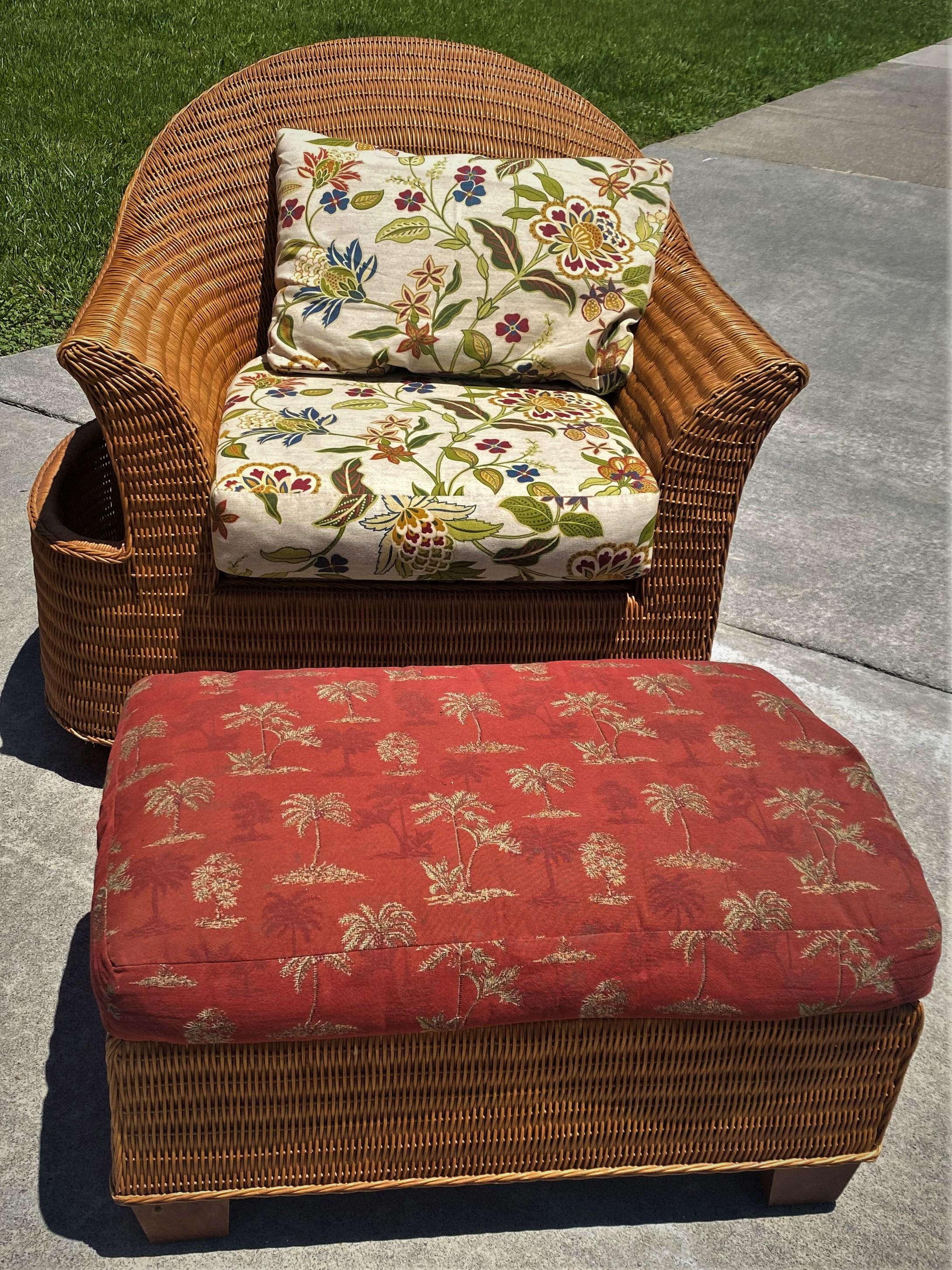 Wonderful modern wicker chair with a magazine holder connected to the side and decorative white background floral upholstery. The ottoman matches the chair except the upholstery. This chair is in good condition it has a tag from M.C, Interiors &