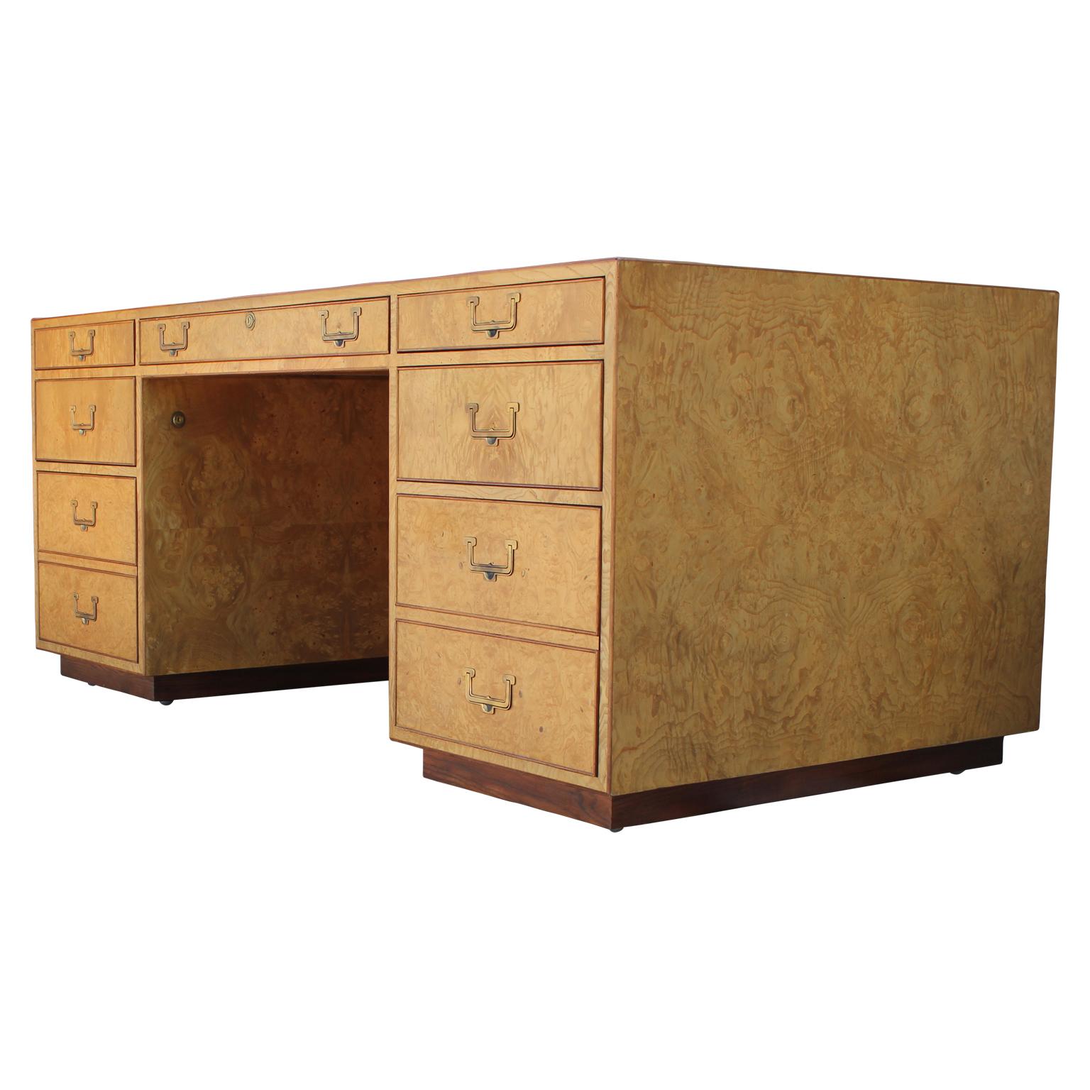 Spectacular modern Campaign style burl wood executive desk with brass hardware designed by John Widdicomb. This piece features nine drawers and a secret pull out panel on the back for an additional work space.
