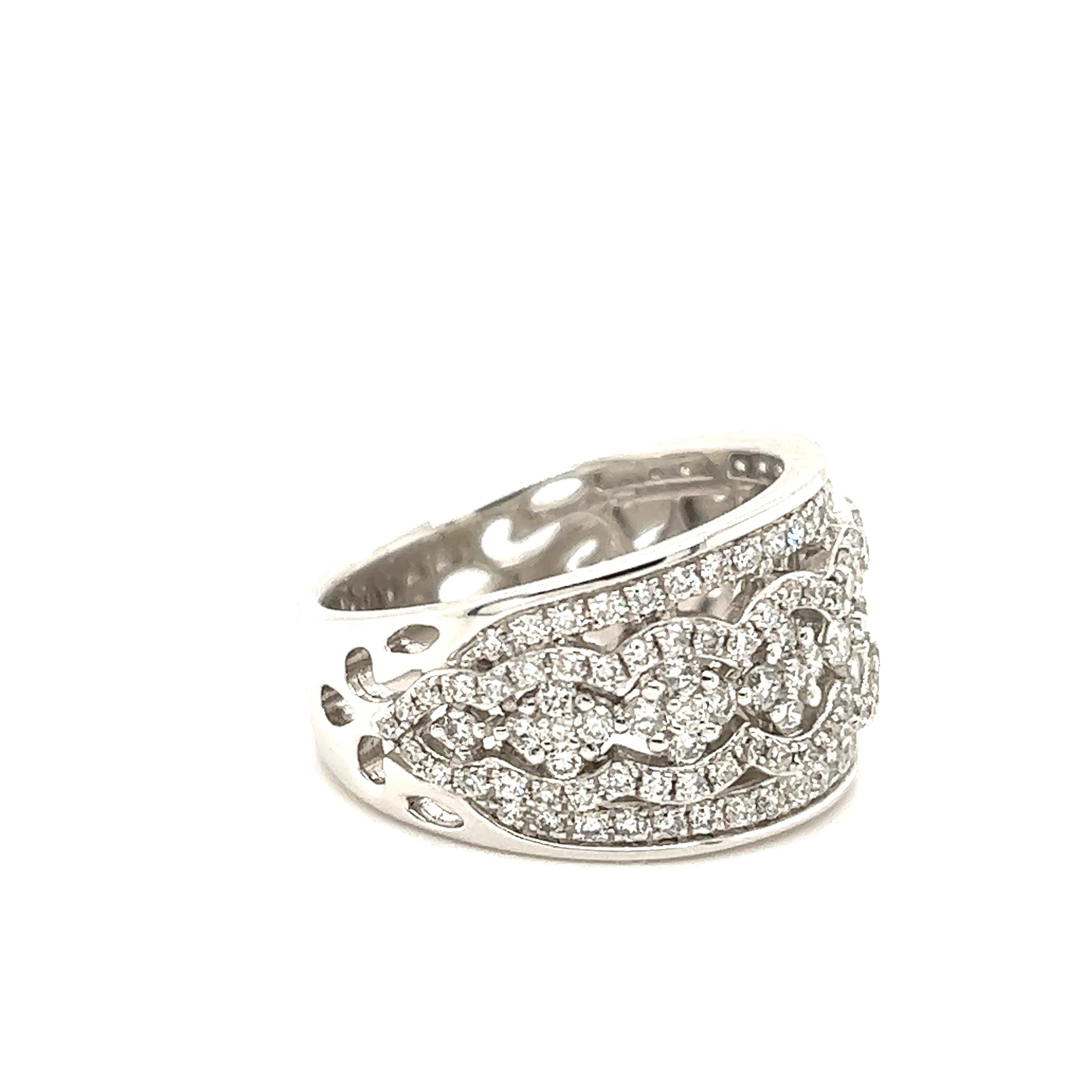 Beautiful ring crafted in 14k white gold. The ring shows a wide band design as the top half measures 12 mm. The brand thins out as it measures 6 mm at the base of the shank. The ring is set with beautiful diamonds approximately 2.01 carat of round