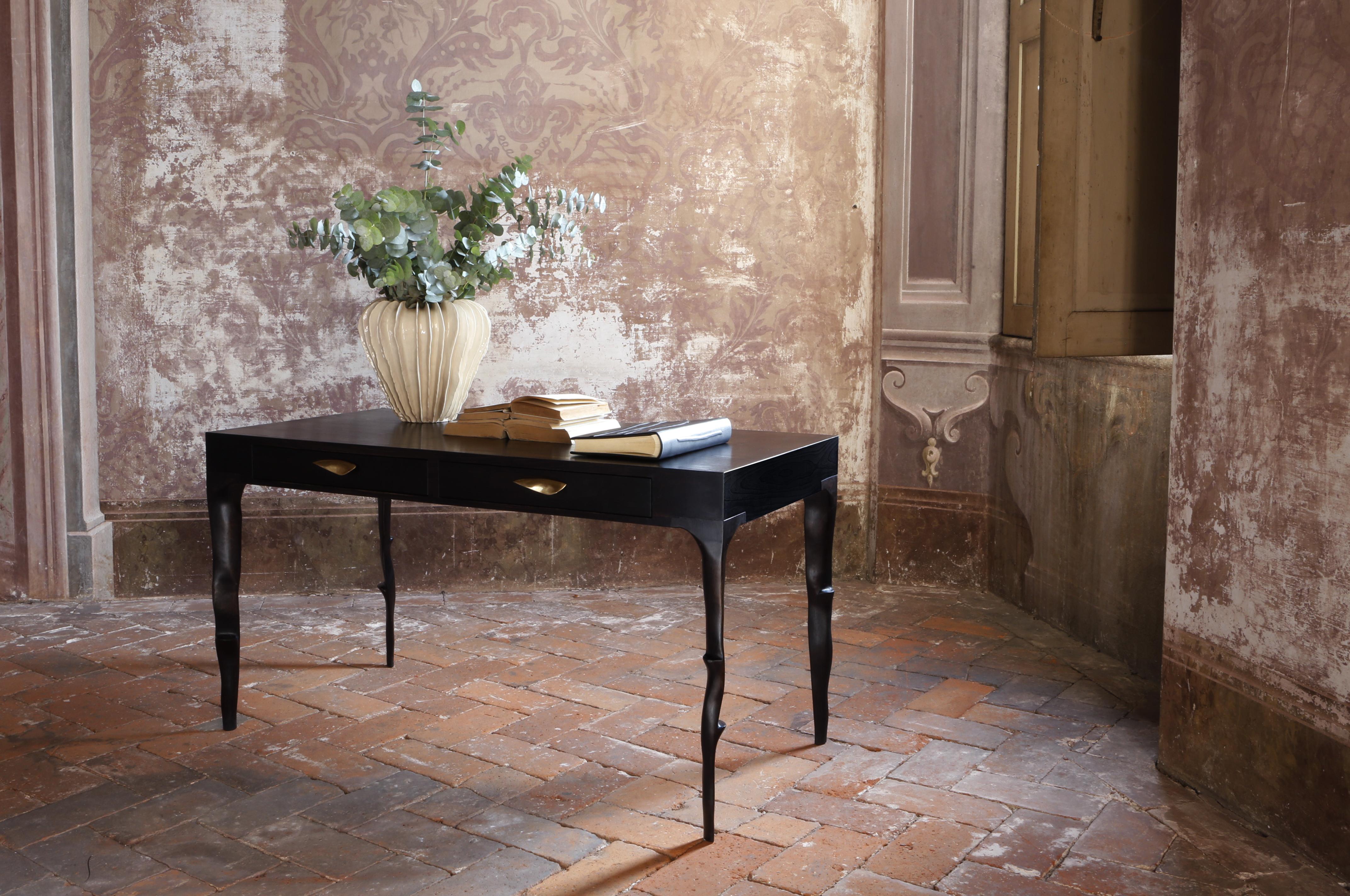 Characterized by clean shapes and linear design, this striking writing desk rests on elegant branch-shaped legs that add a sense of movement to the piece fully handcrafted by Italian master carpenters employing a variety of European and exotic woods