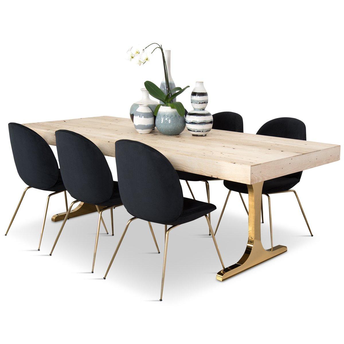 Introducing the Mykonos dining table. A whitewashed solid recycled oak top contrasts shiny brass T-legs in this eye-catching piece. This dining table features the natural beauty and character of recycled oak- each knot, hole, or feature has a story