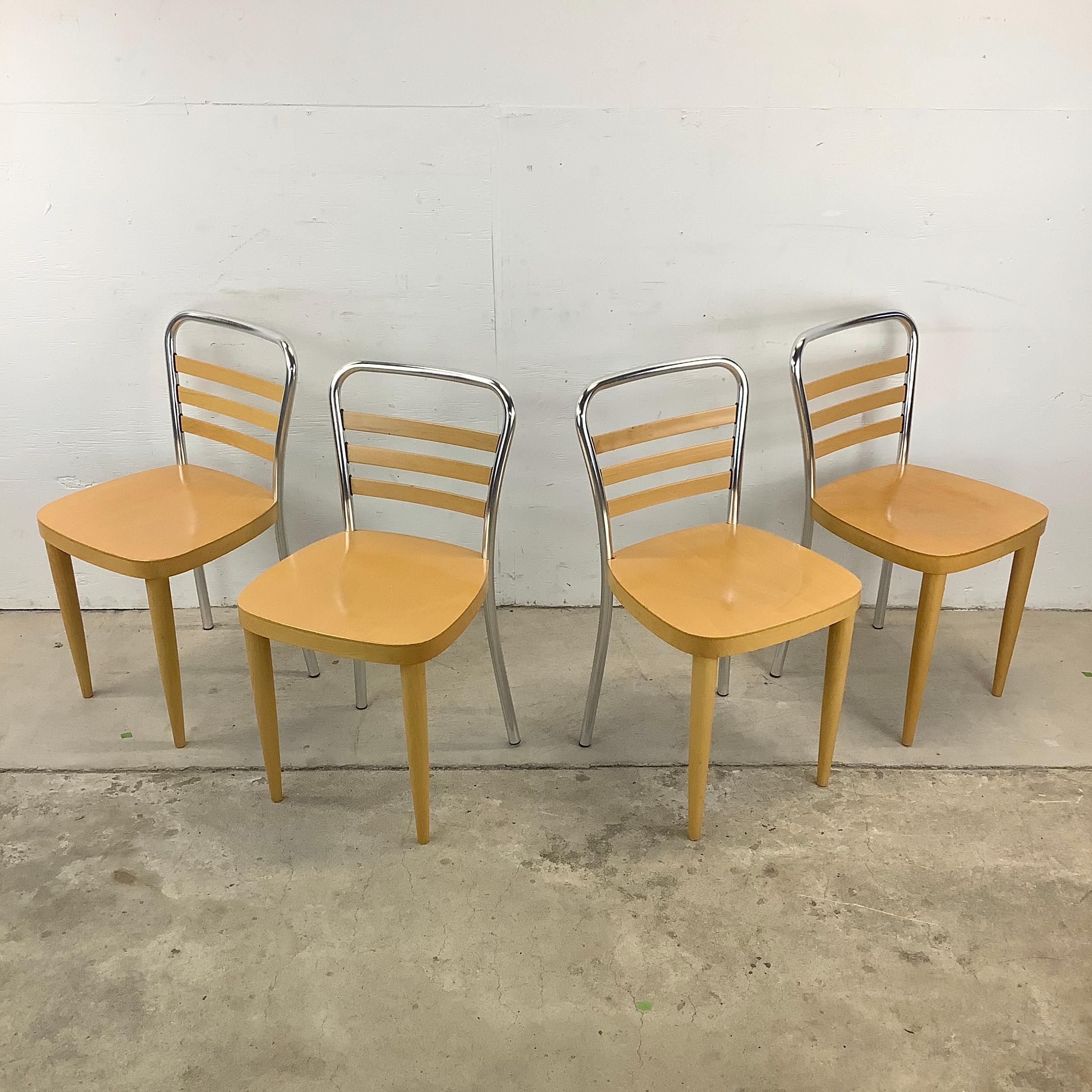 Elevate your dining experience with this striking set of four Modern Dining Chairs, beautifully crafted from a blend of light wood and metal. These chairs are a perfect fusion of contemporary elegance and timeless appeal, adding a touch of