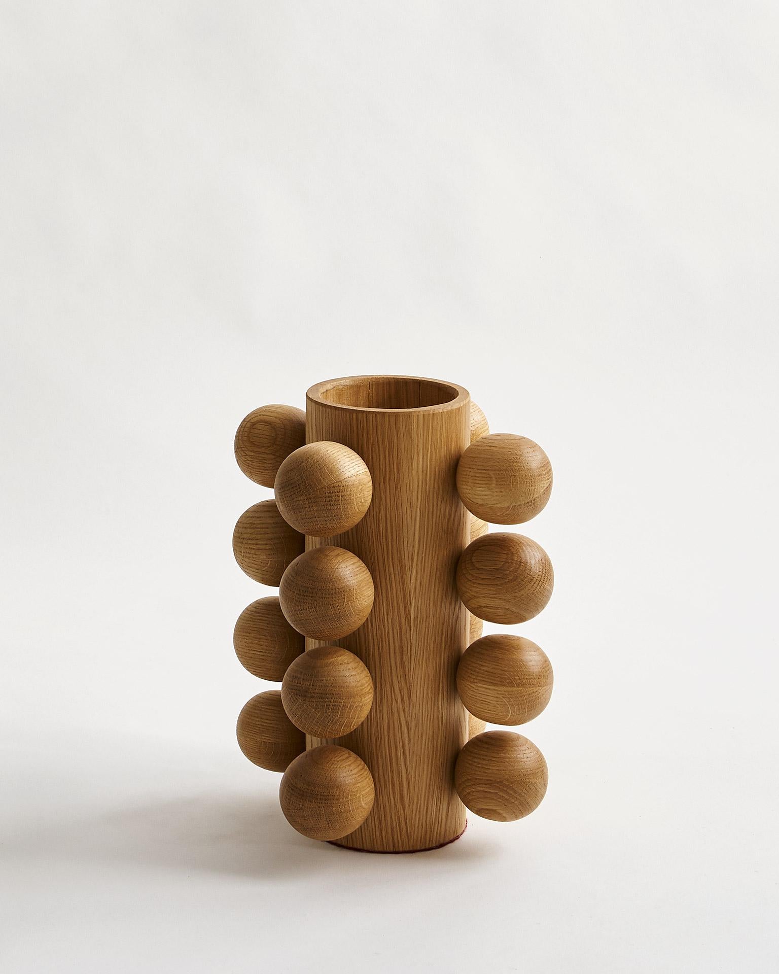 Handcrafted modern wood vase constructed of rift cut white oak with a matte natural poly finish. This made-to-order, eye-catching vase is part of the Studio Line collection, known as the Bubble Vase. Available in white, black, or natural finish. Not