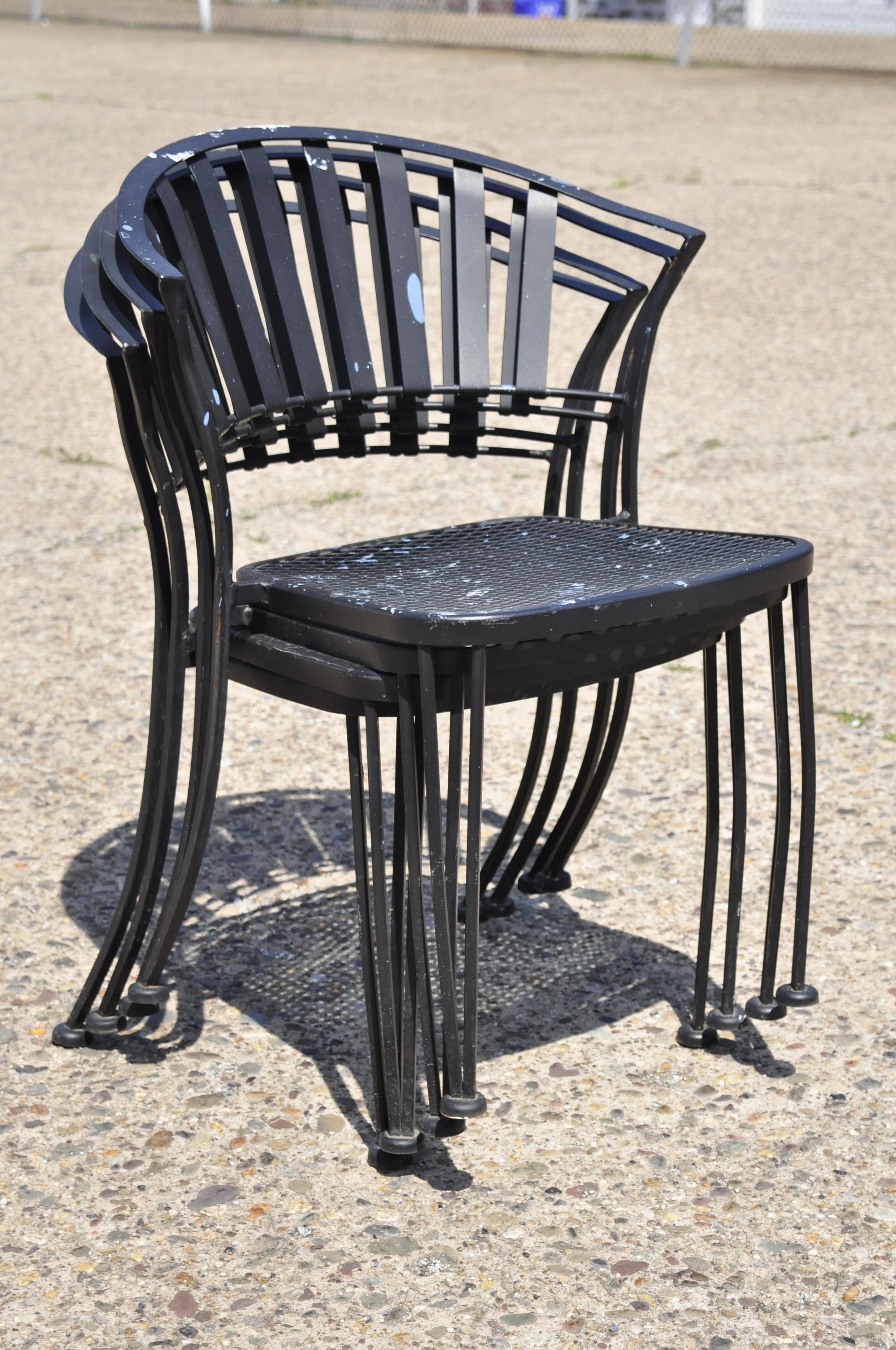 Modern wrought iron barrel back sculptural garden patio dining chairs - set of 4. Item features stacking chairs, wrought iron construction, clean modernist lines, sleek sculptural form. Circa Late 20th century. Measurements: 32