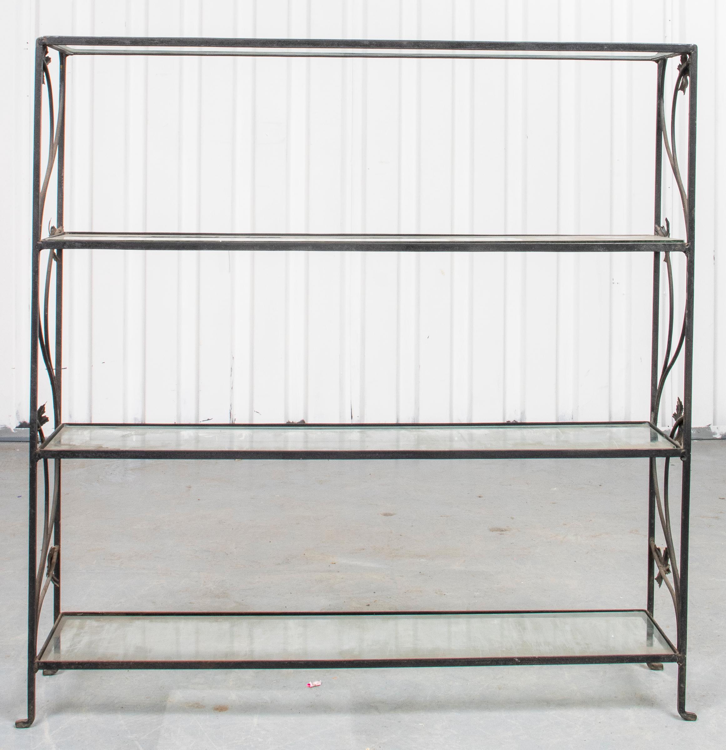 Modern wrought iron four tier étagère with foliate motif on the sides and glass shelves. Measures: 38.5” H x 37.5” W x 9” D.