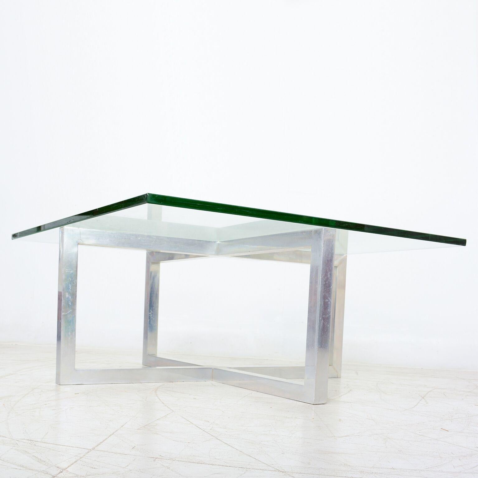 Coffee Table
Vintage Modern Coffee Table in the style of Paul Mayen. USA circa 1970s.
Unmarked.  Aluminum frame and Glass Top.
Dimensions: 36 x 36 X 16 H
Aluminum X frame is solid and sturdy. Aluminum polished. Original glass with light scuffs on