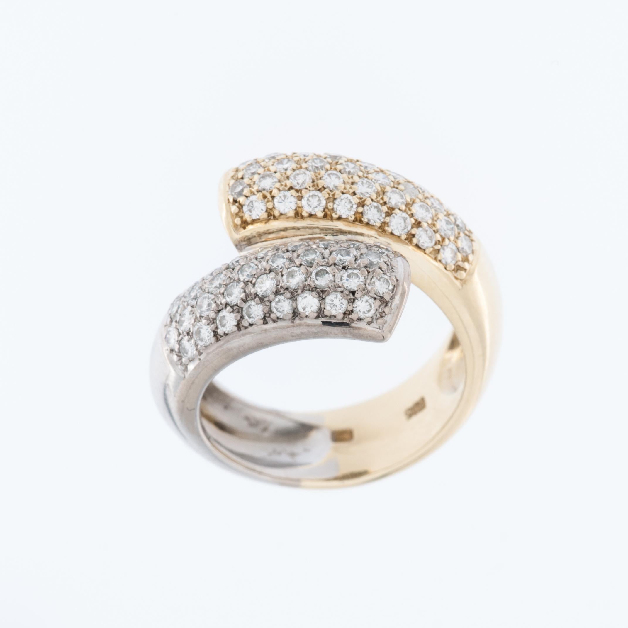 This modern half yellow and half white gold diamond cocktail crossover Swiss ring is a special piece of jewelry. The ring features a design where the band splits into two halves, with one half made of yellow gold and the other half made of white