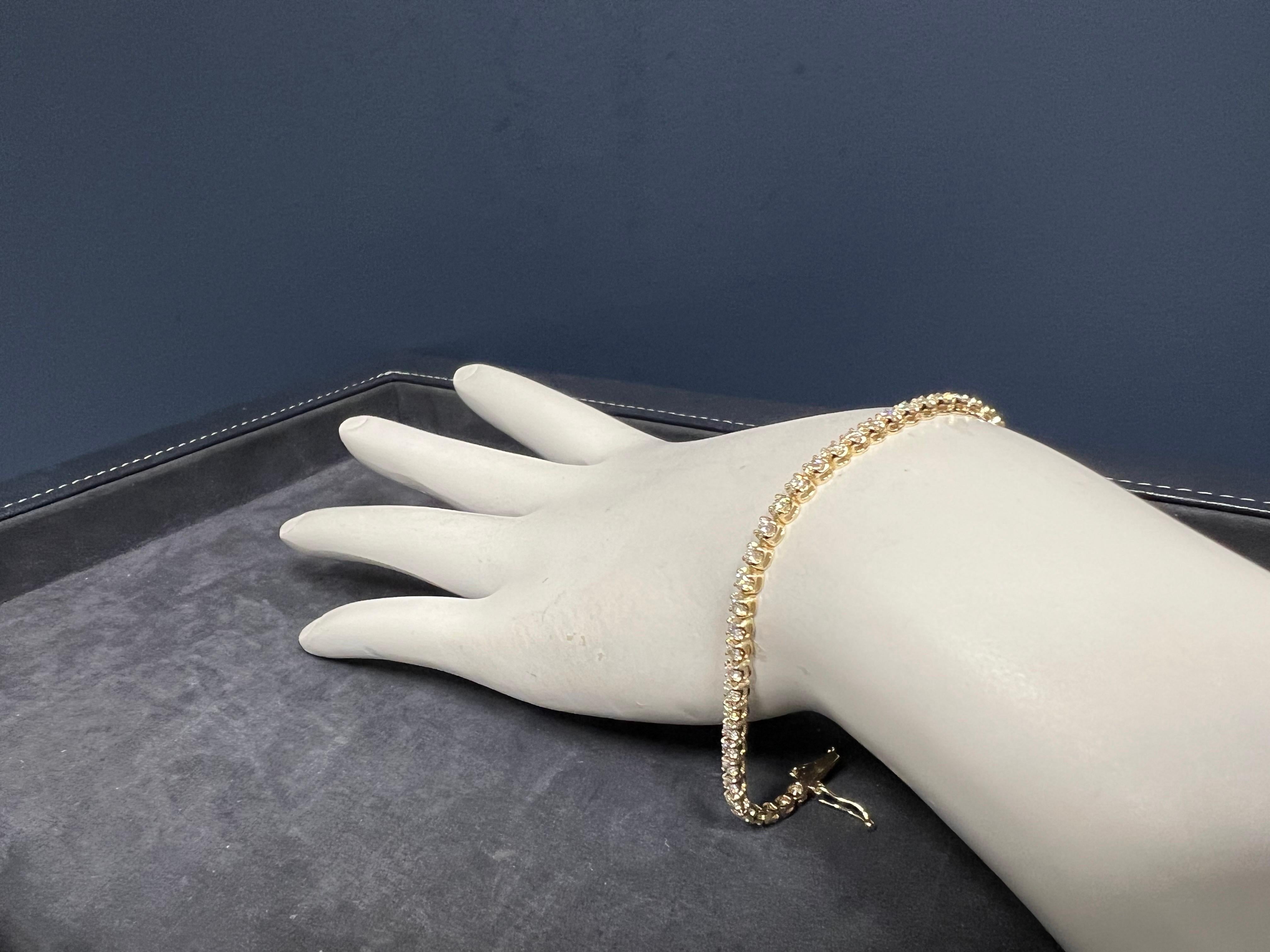 Modern 14k Yellow Gold 2.00 Carat Natural Round Brilliant G-H VS (appx) Diamond Tennis Bracelet.

The piece is set with 58 natural round brilliant diamonds. 

The bracelet weighs 6.1 grams and is 7
